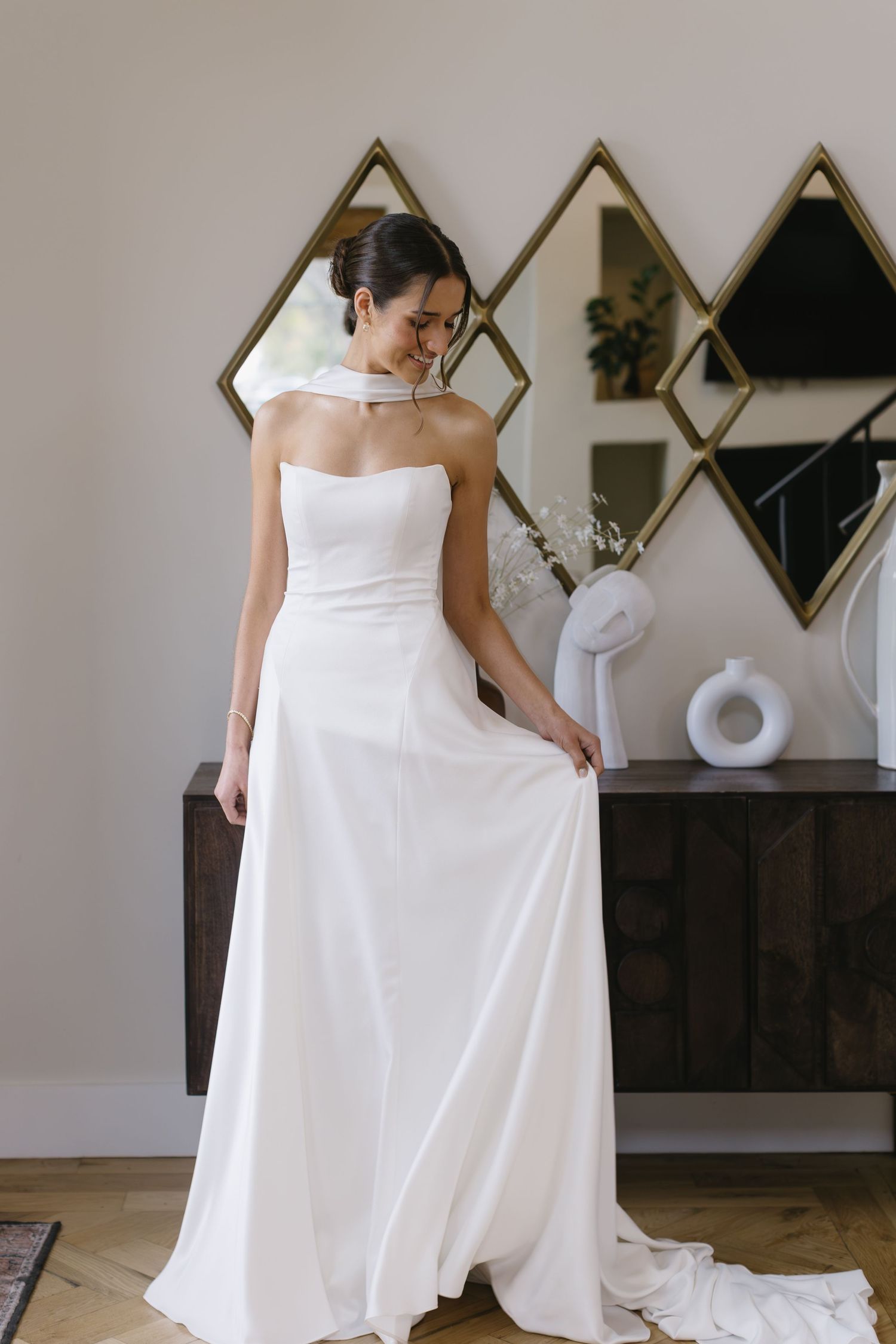 A bride in a modern white wedding dress twirls to show the flowing skirt and elegant design.