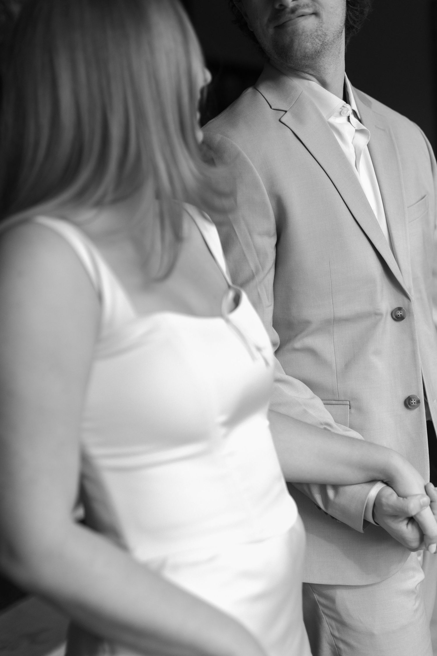Close-up artistic shots of a couple in white and beige formal wear.