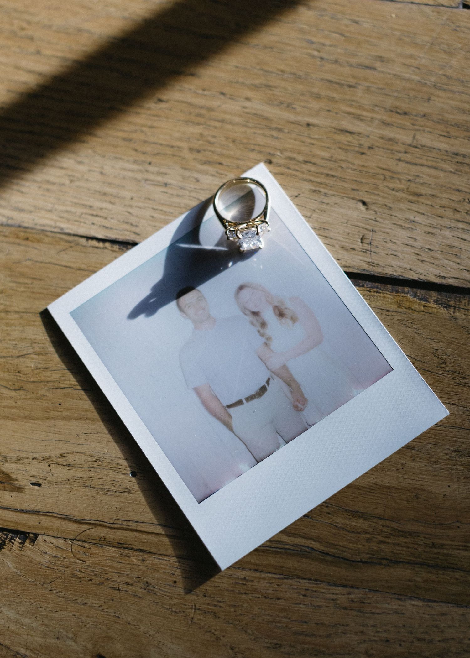 Polaroid photos displayed on a rustic wooden surface.