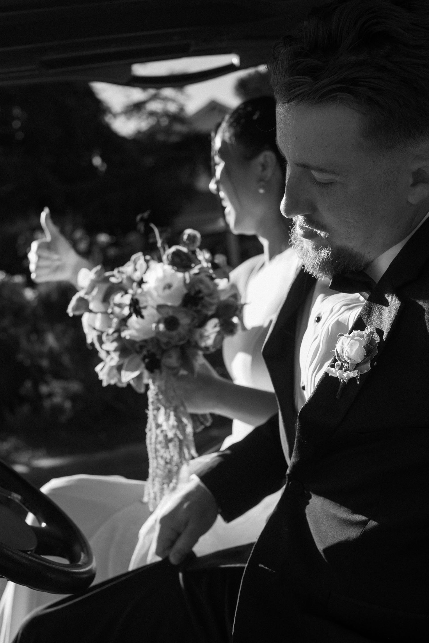 Dramatic black and white wedding photo showing silhouettes during an intimate moment.