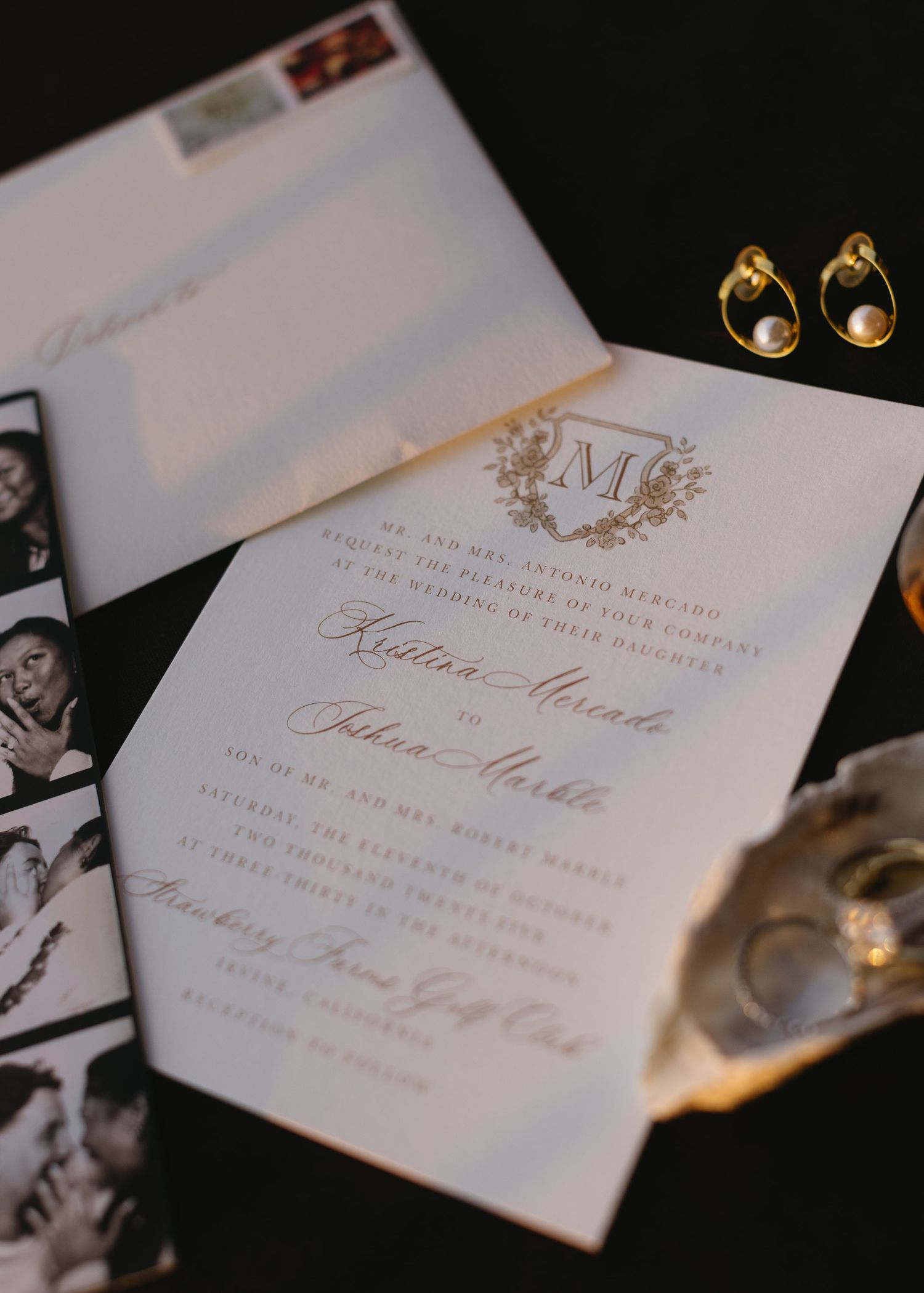 Elegant wedding invitations with monogram details and calligraphy displayed on dark background.