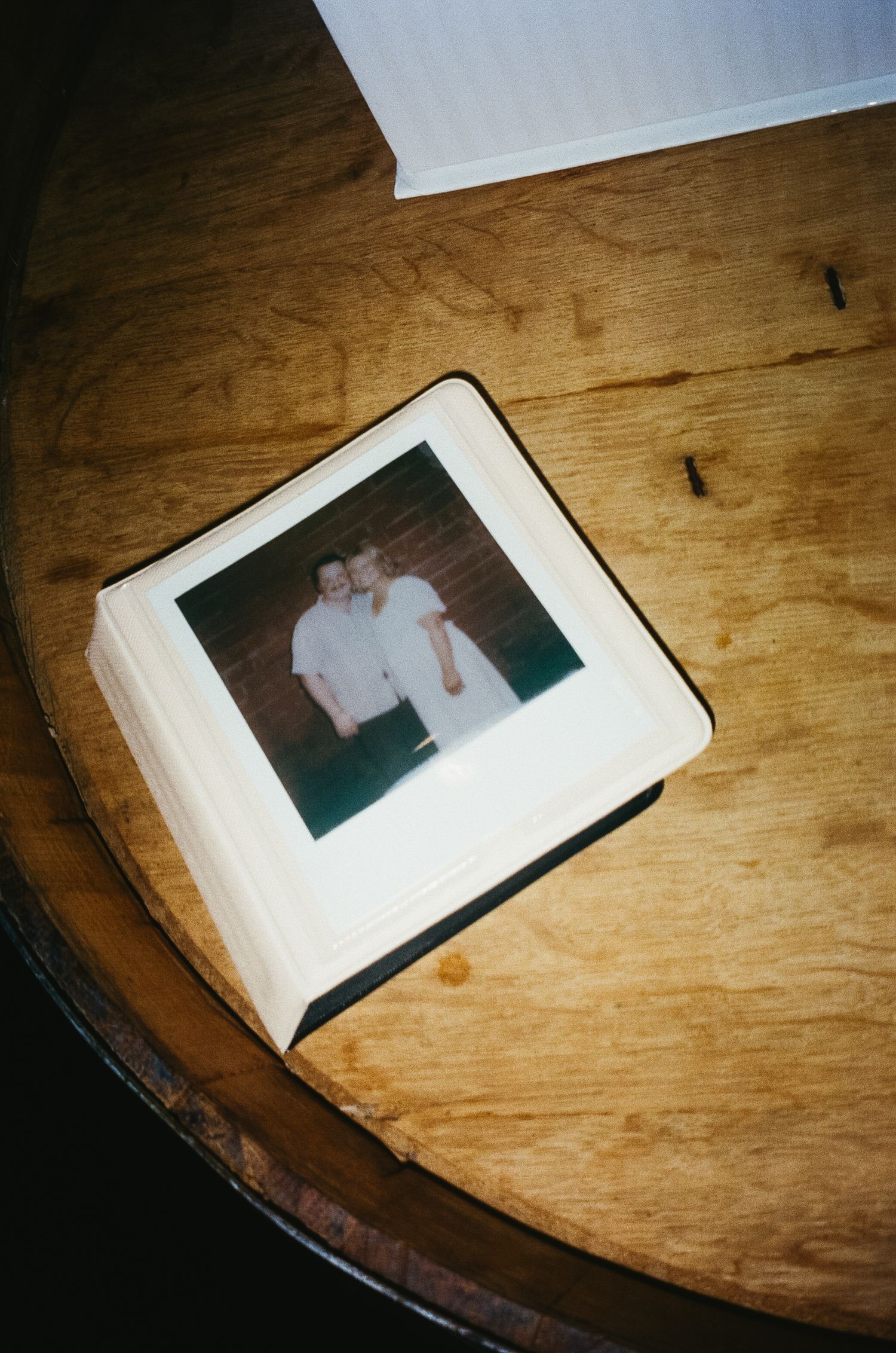 Vintage-style photographs displayed on a weathered wooden surface.