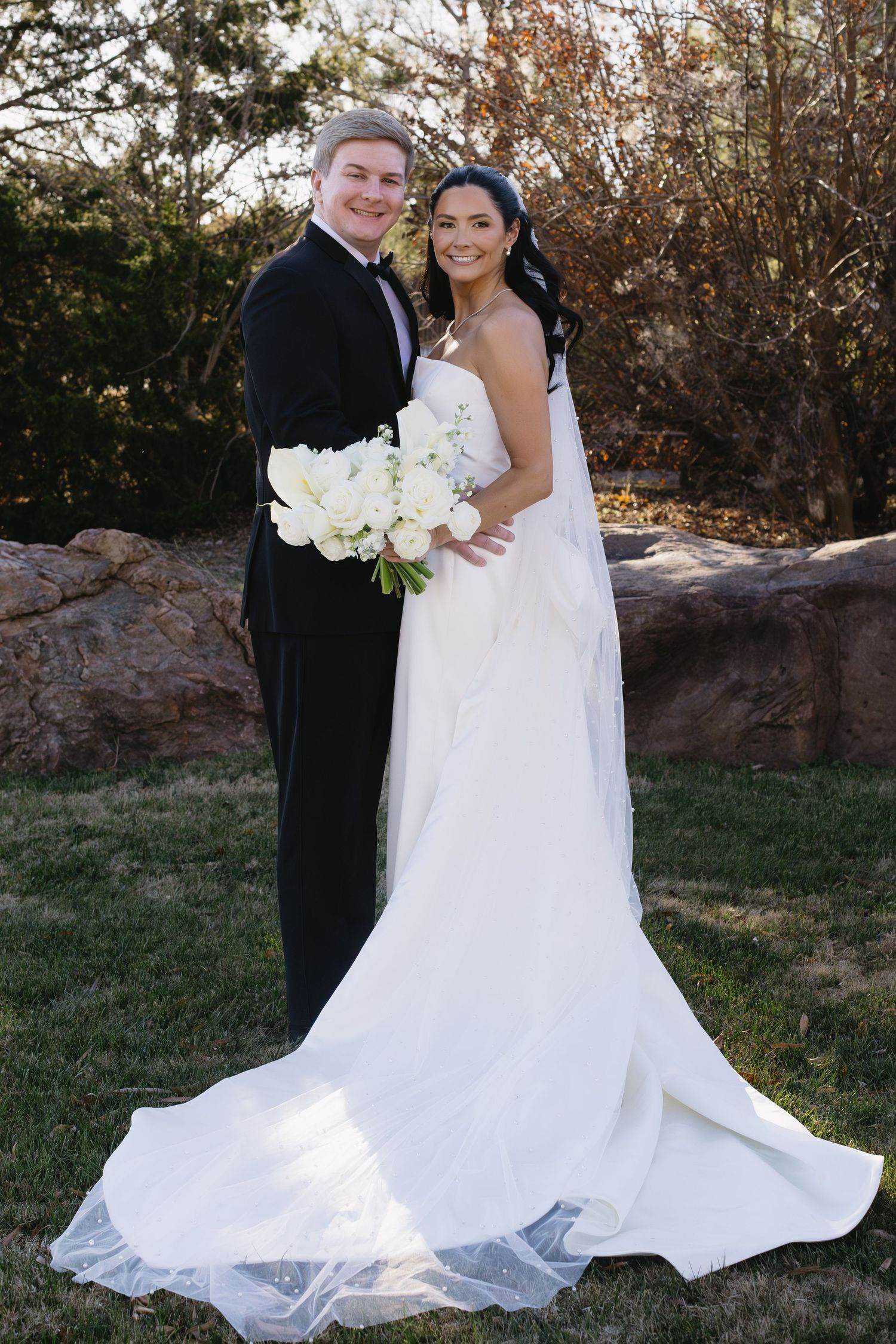 A romantic wedding portrait series with a flowing white dress and bouquet in an outdoor autumn setting.