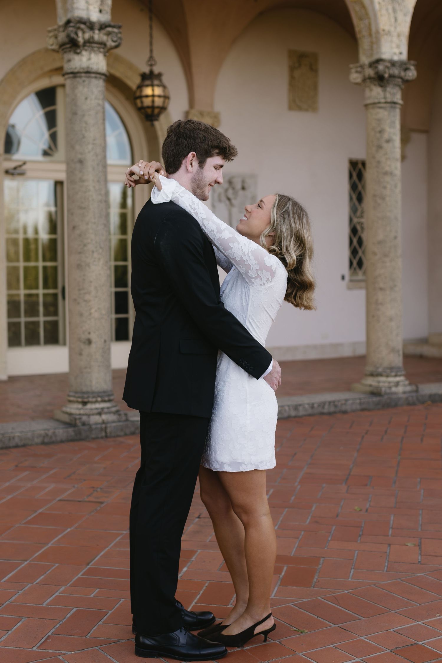 A romantic dance sequence shows a couple twirling on a Spanish-style patio with terracotta tiles.