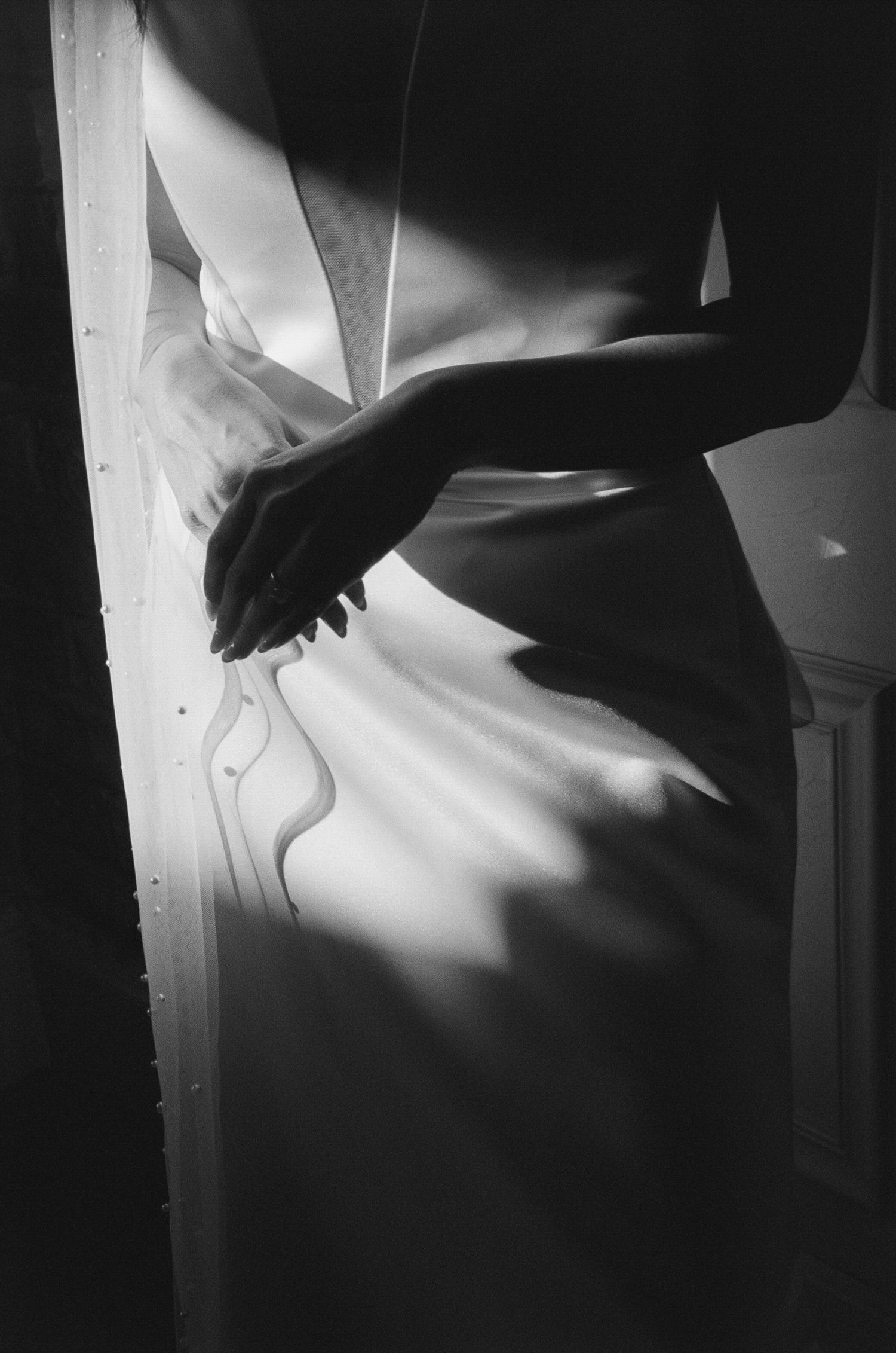 Dramatic black and white photography of fabric details in contrasting light.