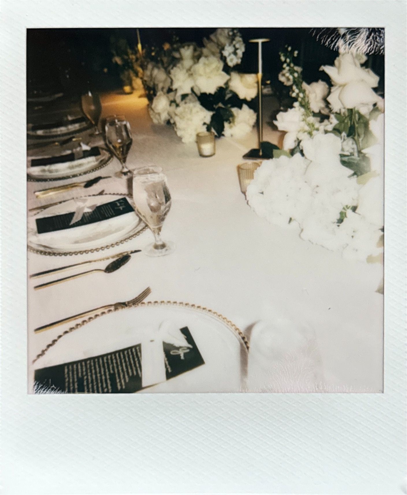 Polaroid-style photos showing elegant wedding reception table settings with white floral arrangements.
