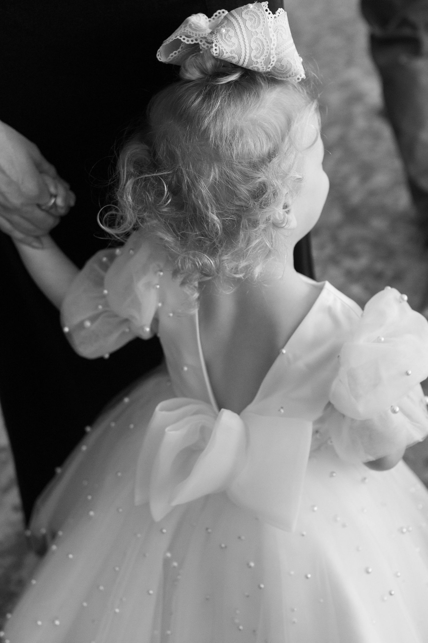 Close-up detail of white beaded fabric from a wedding dress.
