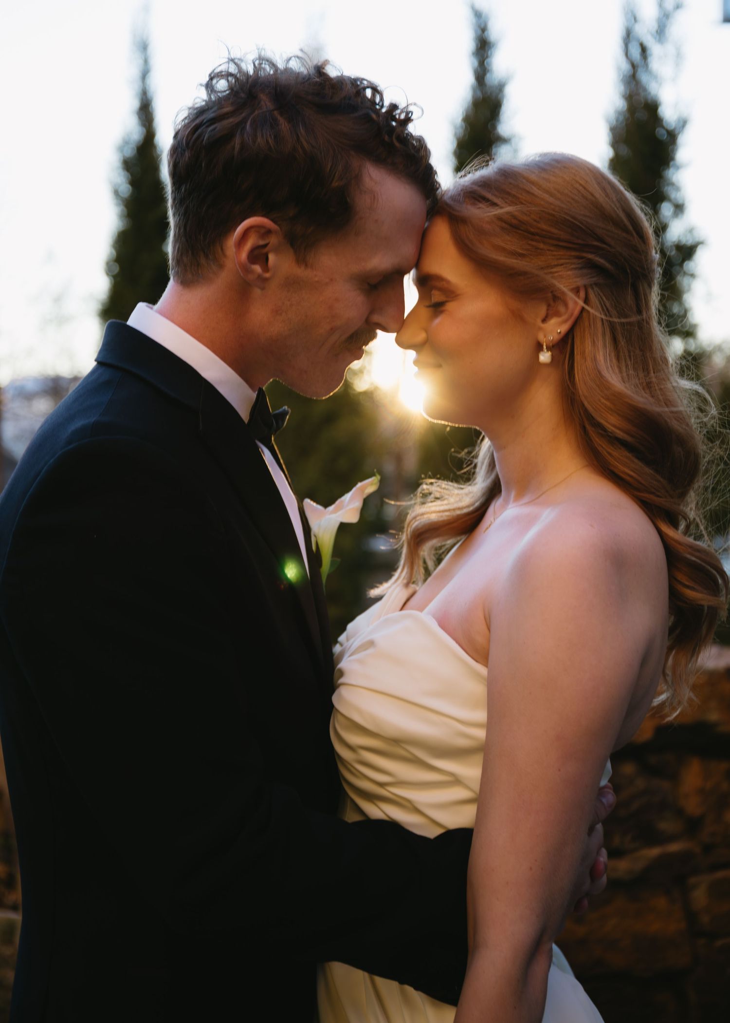 Romantic sunset portraits of the couple in formal wedding attire.