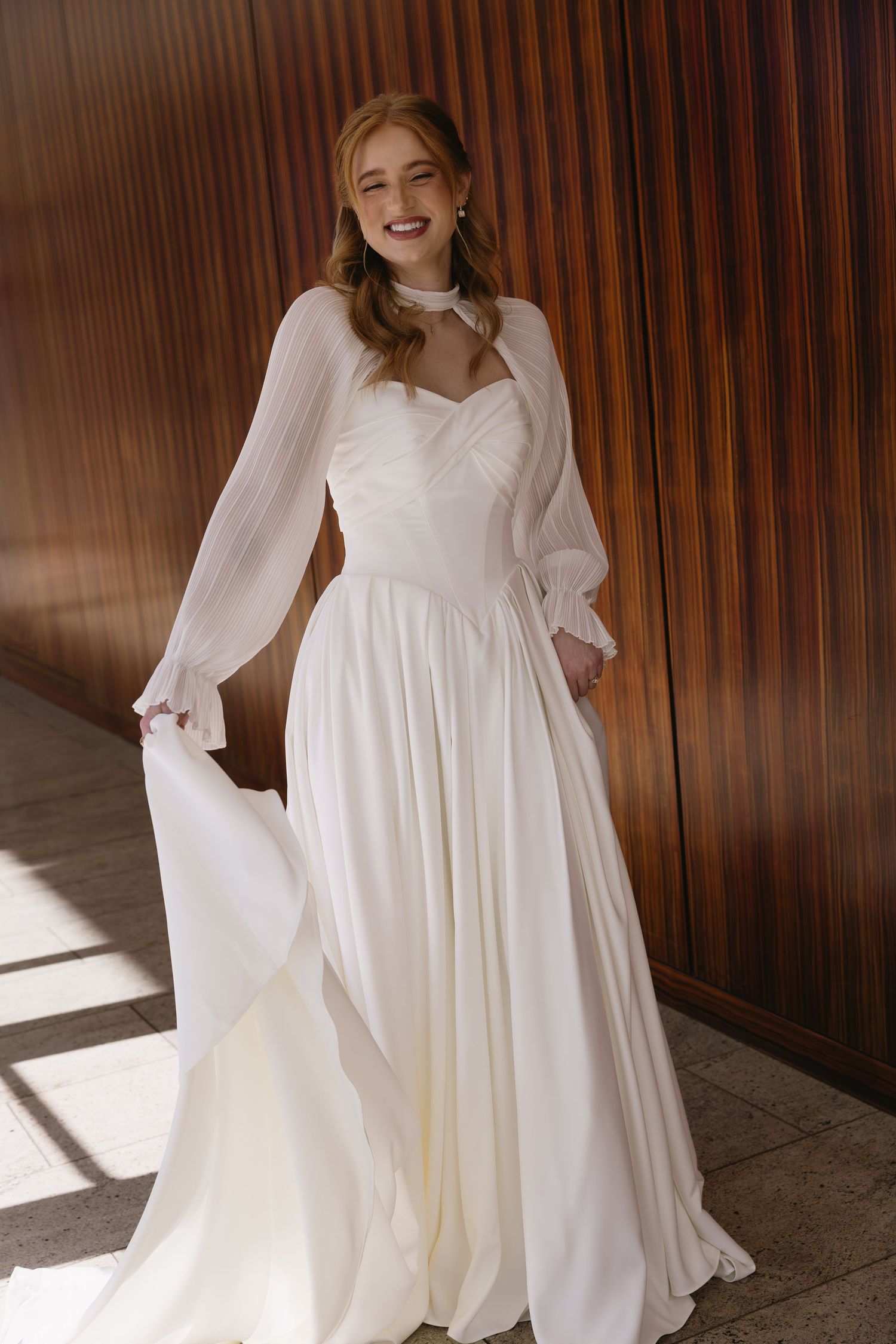 Ethereal wedding dress with billowing sleeves and sweetheart neckline in natural light.