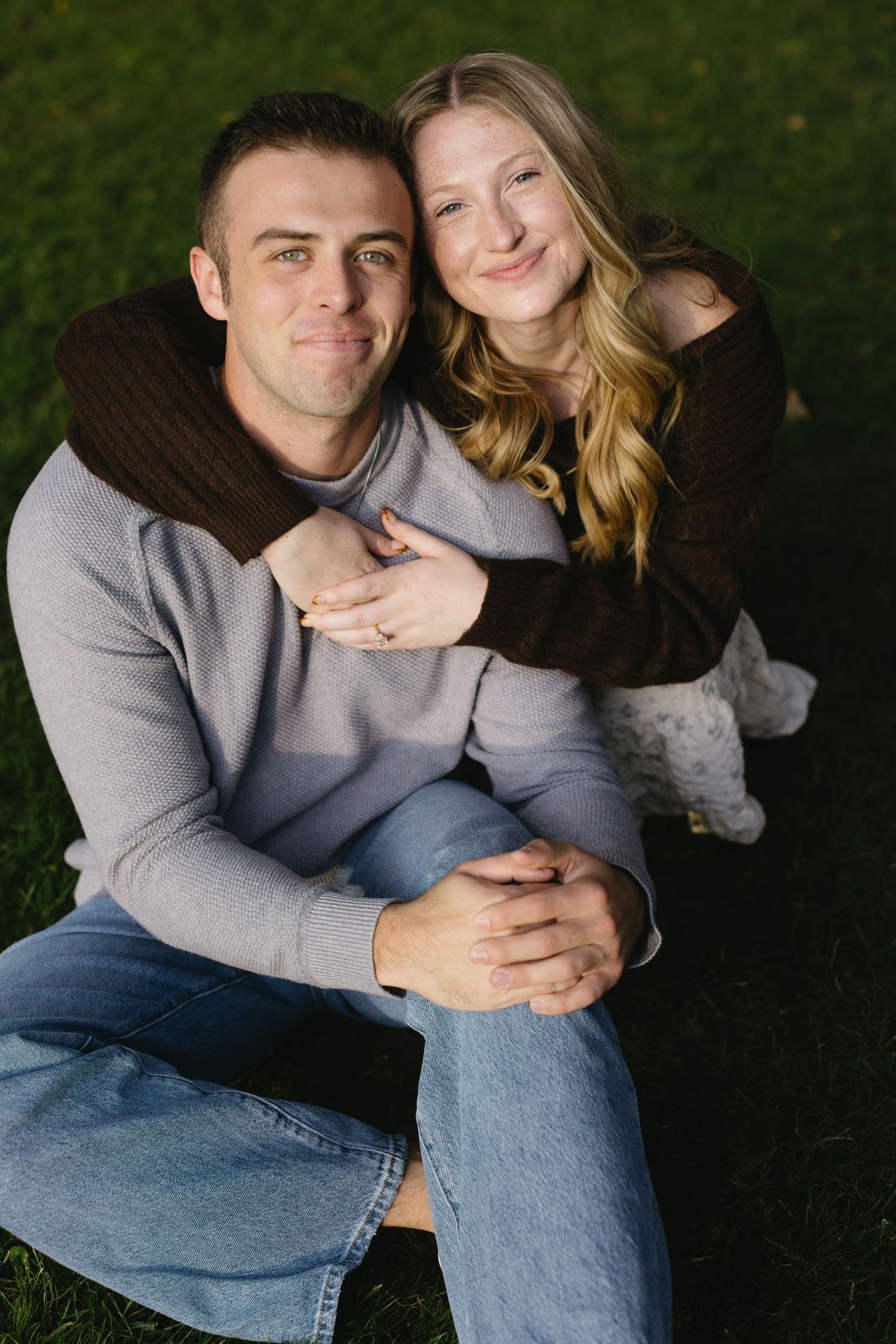 Couple in casual wear sharing intimate moments on grass in a series of candid poses.