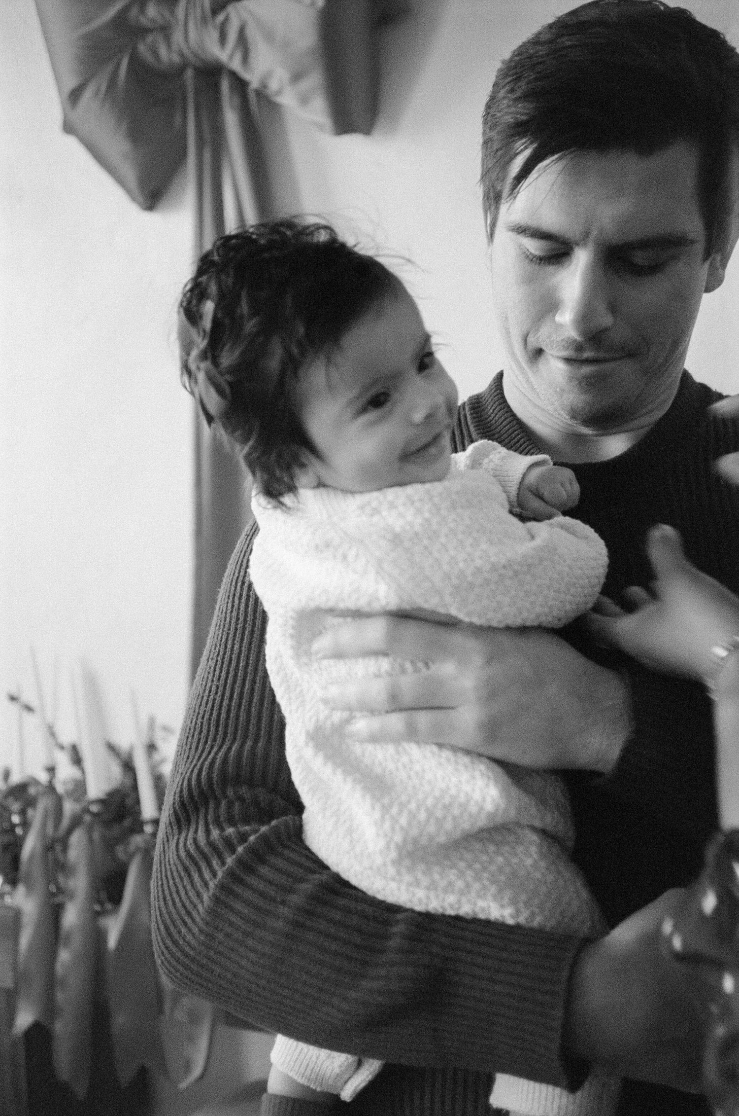 Black and white photo series showing tender embraces against a soft background.
