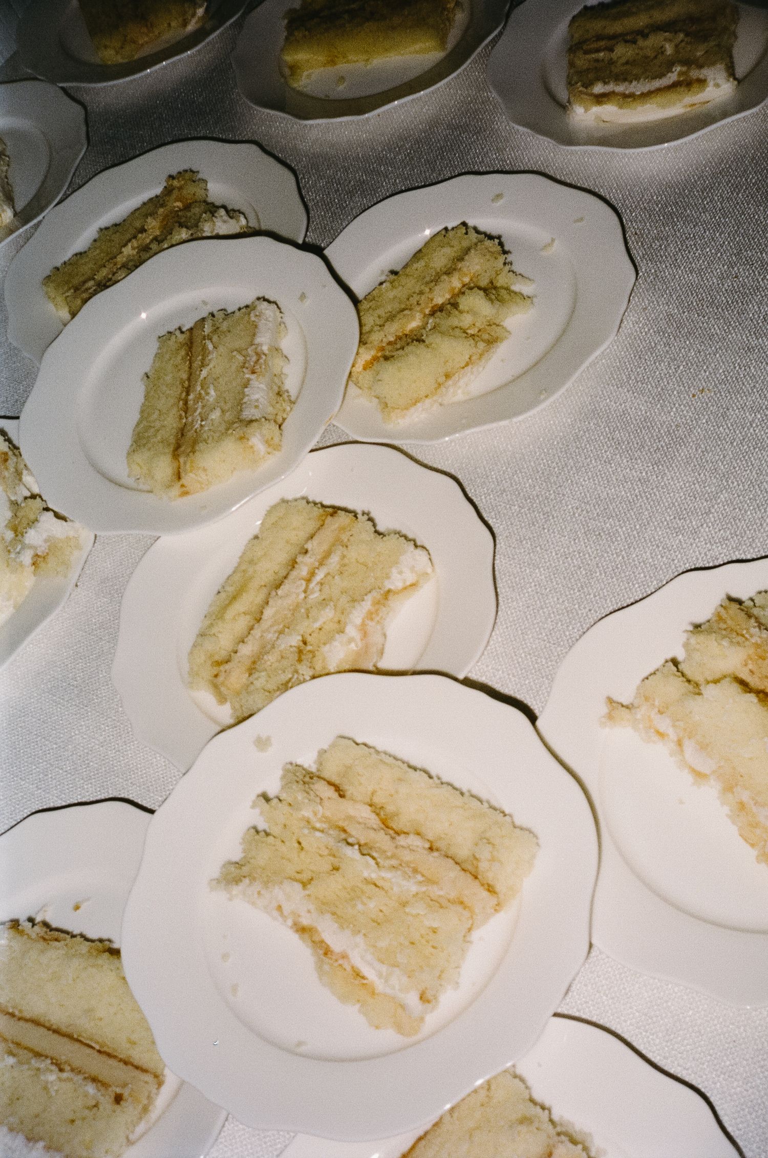 Slices of white wedding cake arranged on small plates for serving.