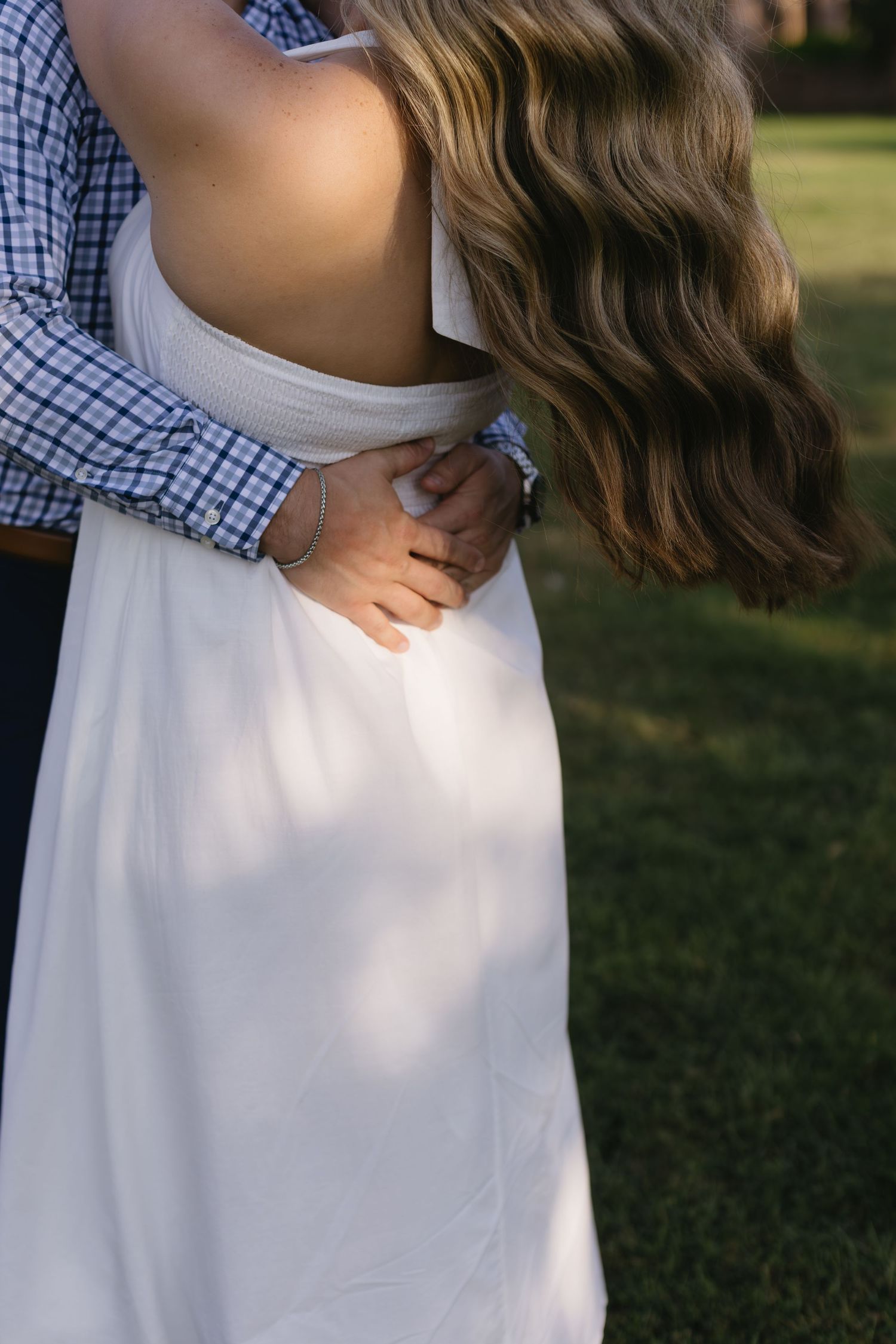 Collage showing multiple views of a couple in checkered shirt and white dress embracing in a sunlit outdoor setting.
