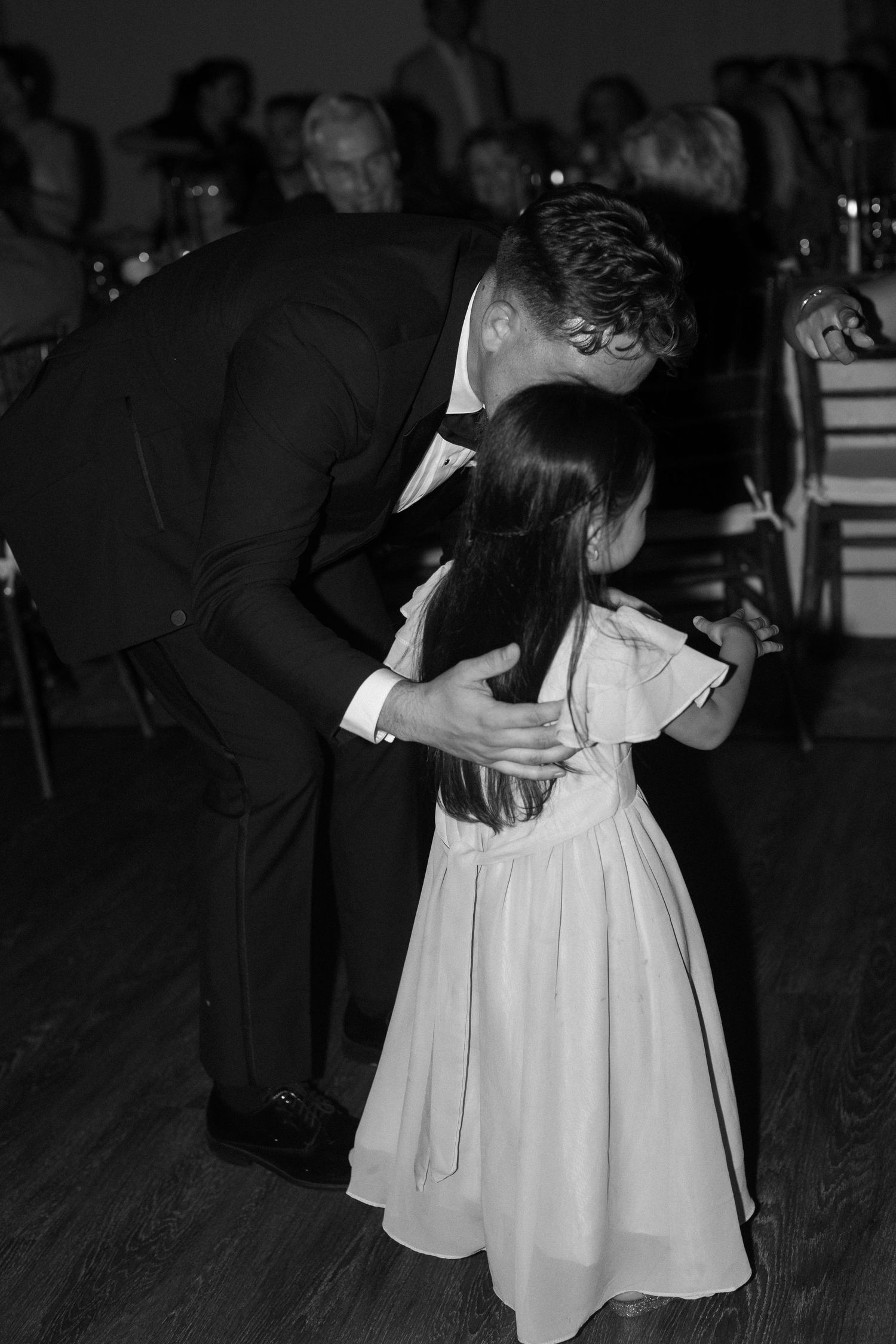 Black and white photo of couples dancing at an elegant wedding reception.