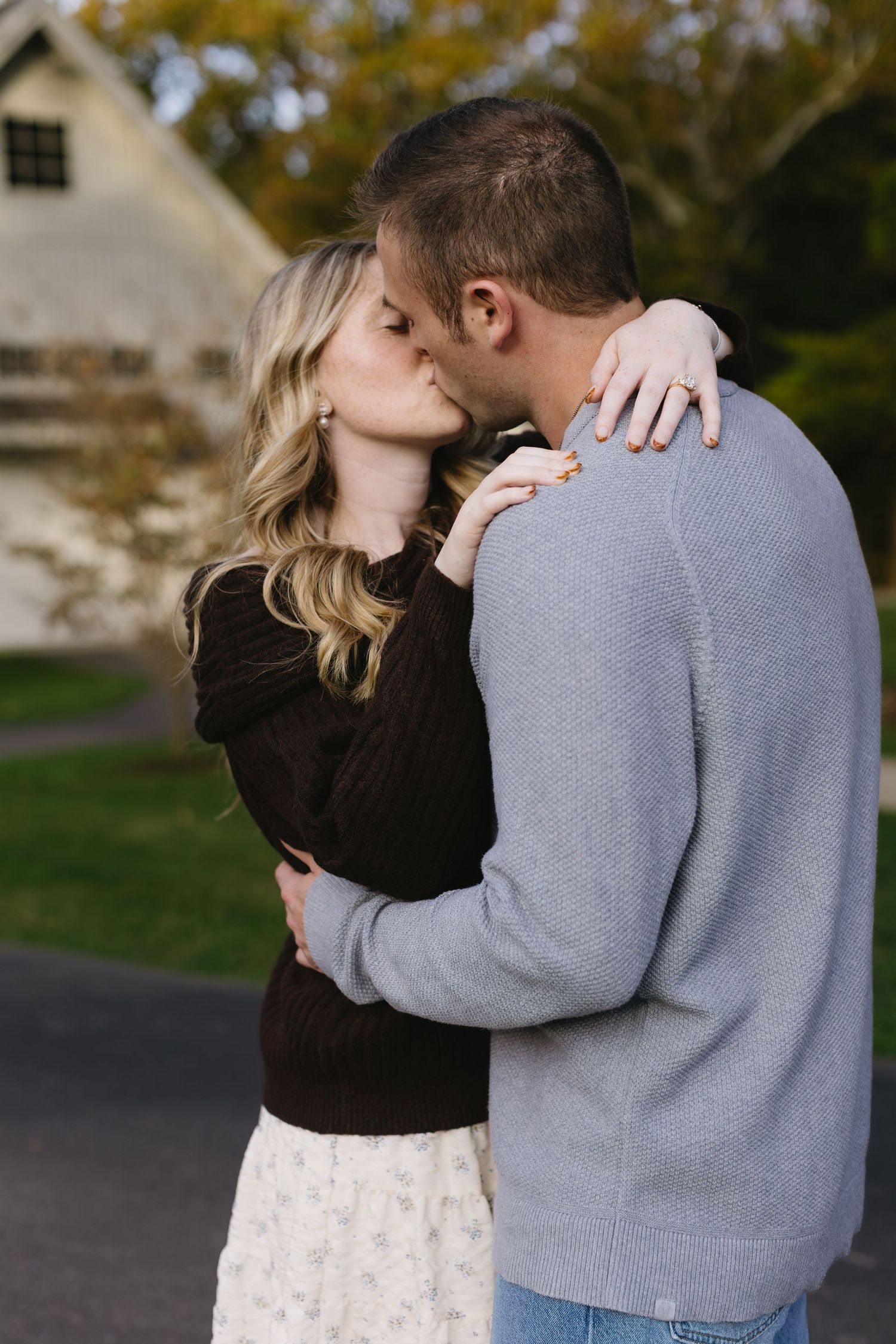 An intimate moment shared between a couple during a fall photoshoot.