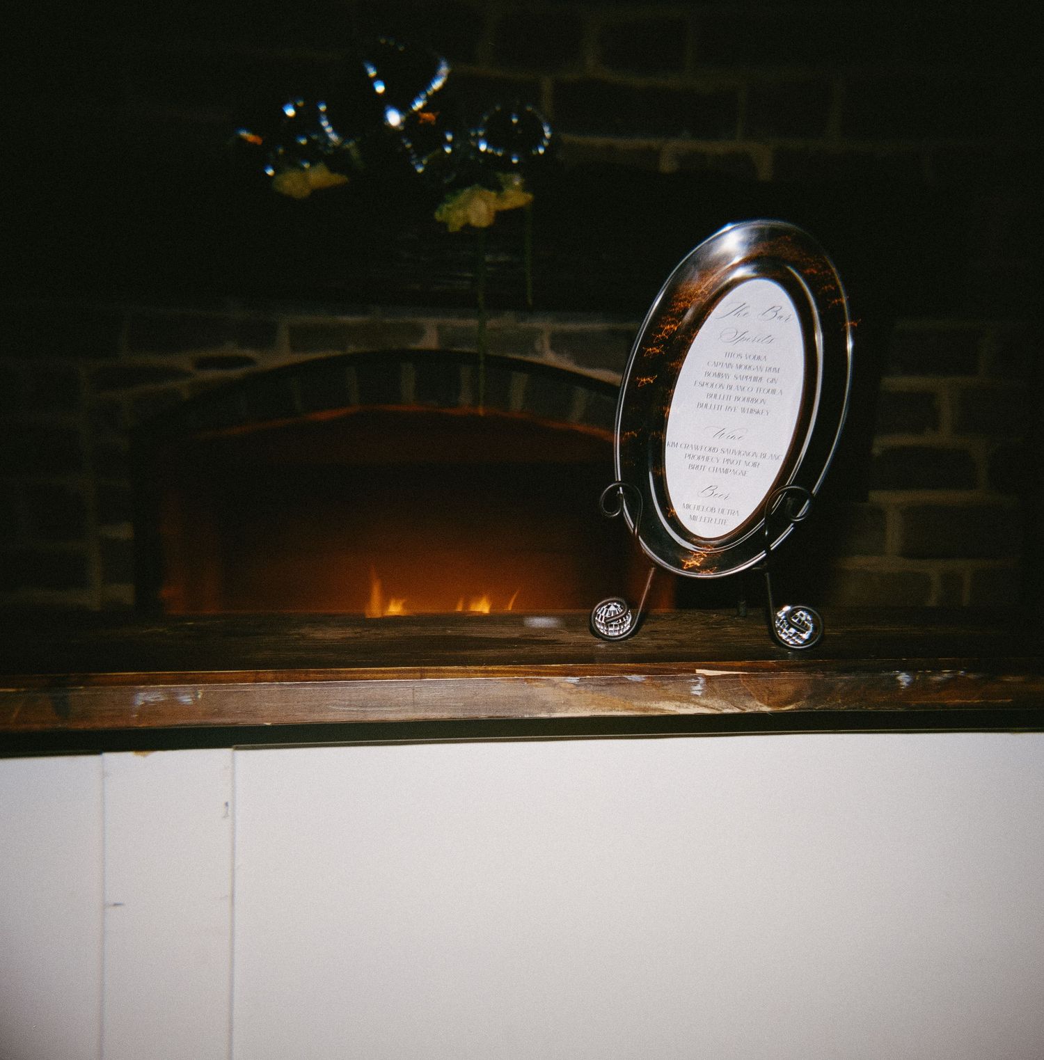 Dark wooden surface with decorative wine bottle labels displayed in a row.