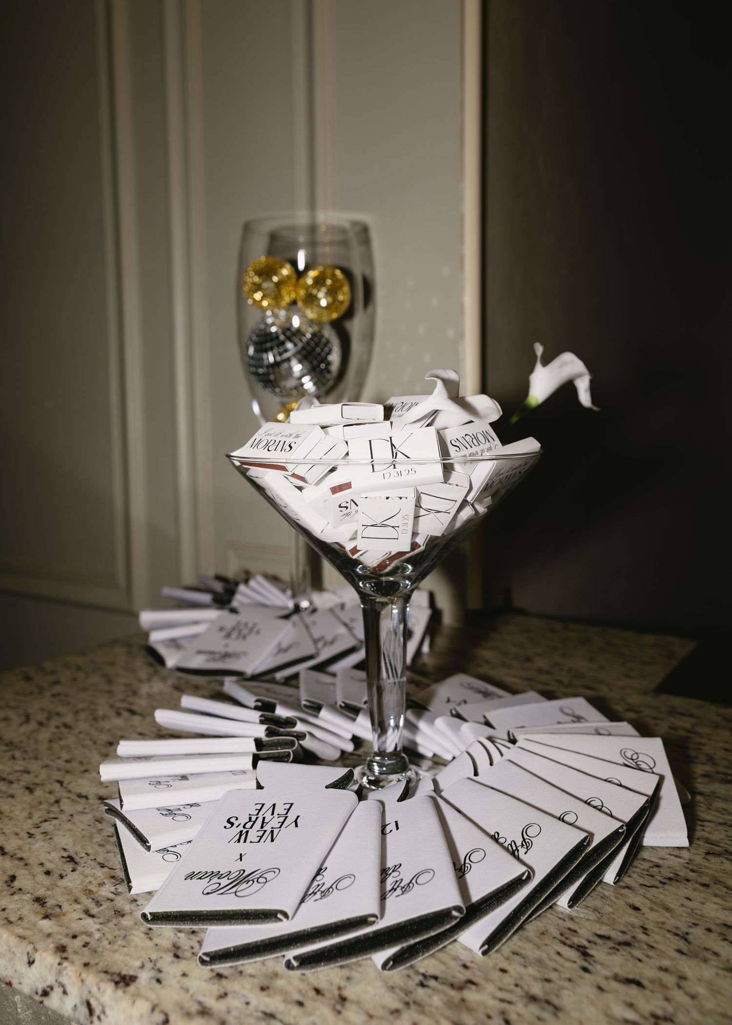 Wine glass surrounded by scattered paper notes on a granite countertop.