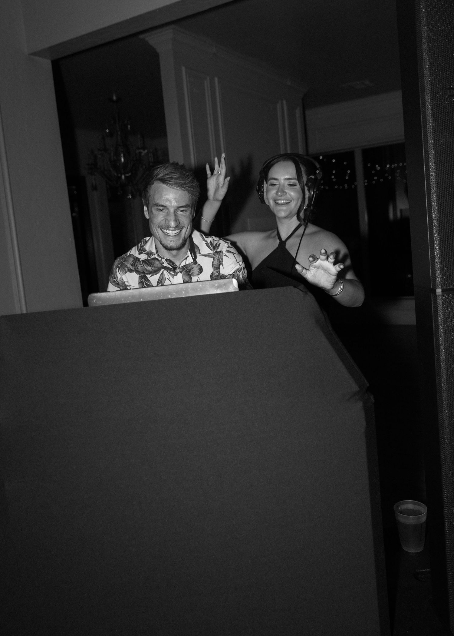 Wedding guests enjoying themselves at a dimly lit reception venue.