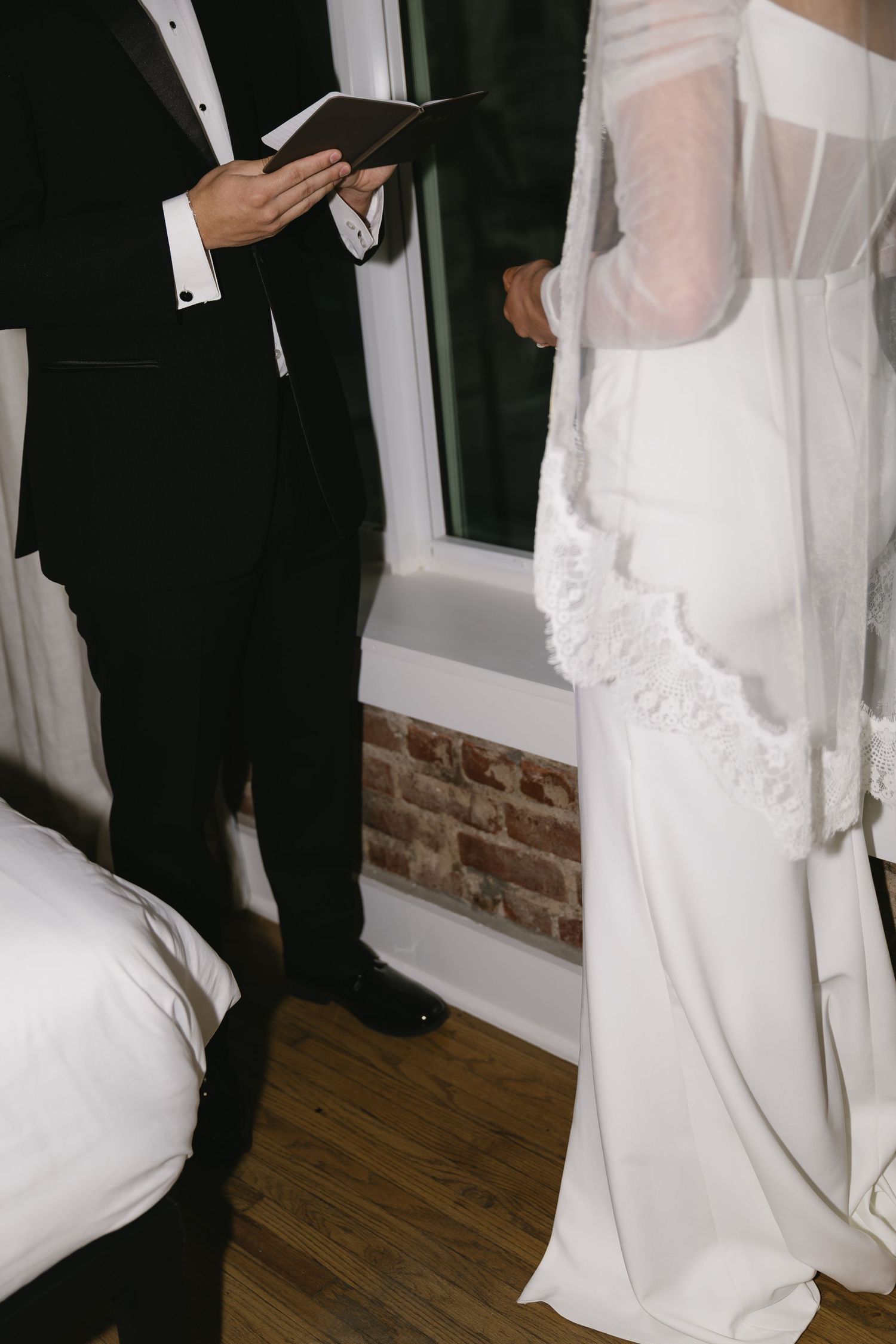 Close-up shots of bride in white dress and groom in black suit during wedding ceremony.