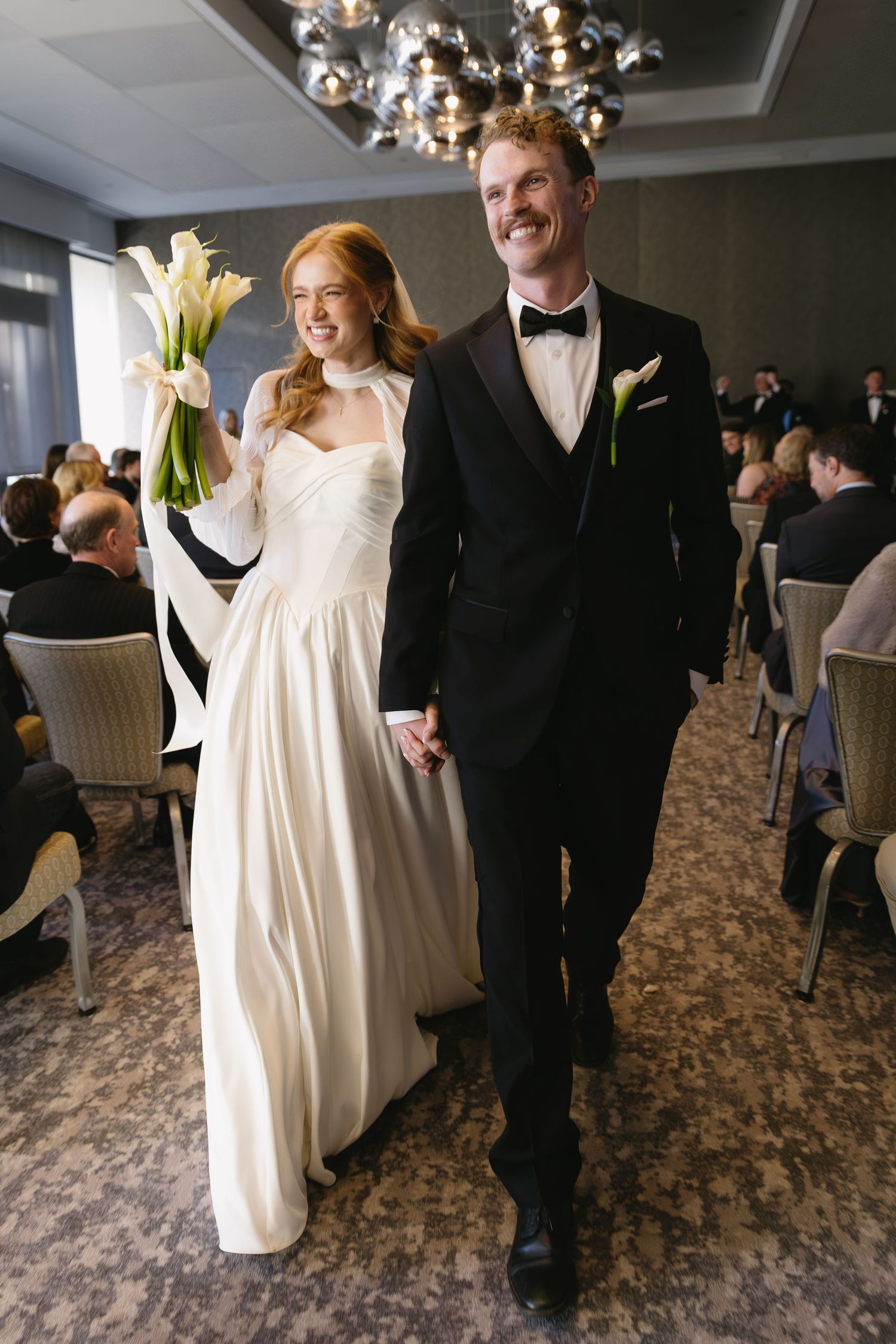 Wedding celebration in an elegant indoor venue with formal attire.