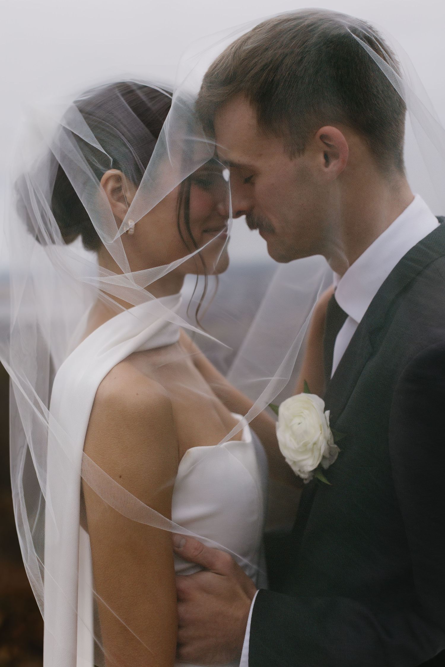 Romantic wedding couple shares intimate kisses in a series of artistic black and white portraits.