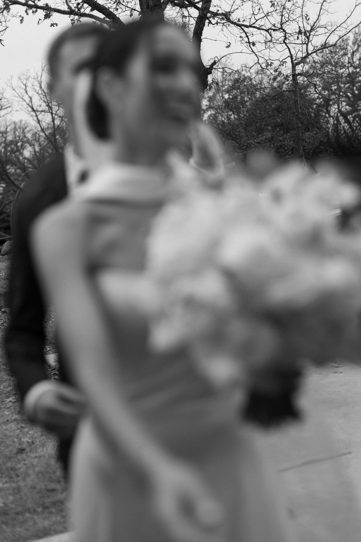 Black and white wedding portrait captured in natural outdoor setting.