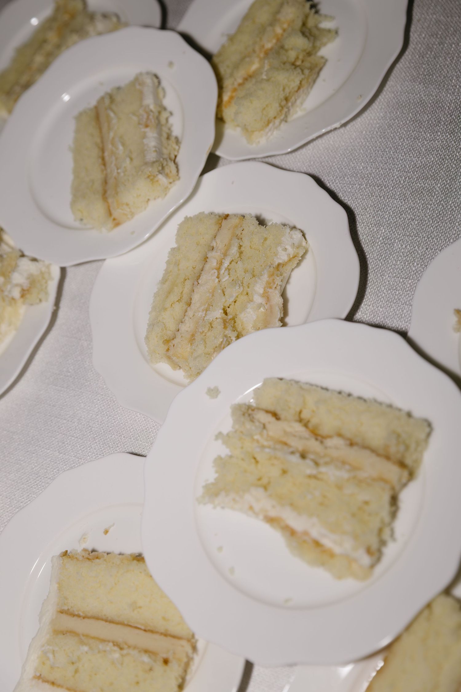 Slices of white wedding cake arranged on small plates for serving.
