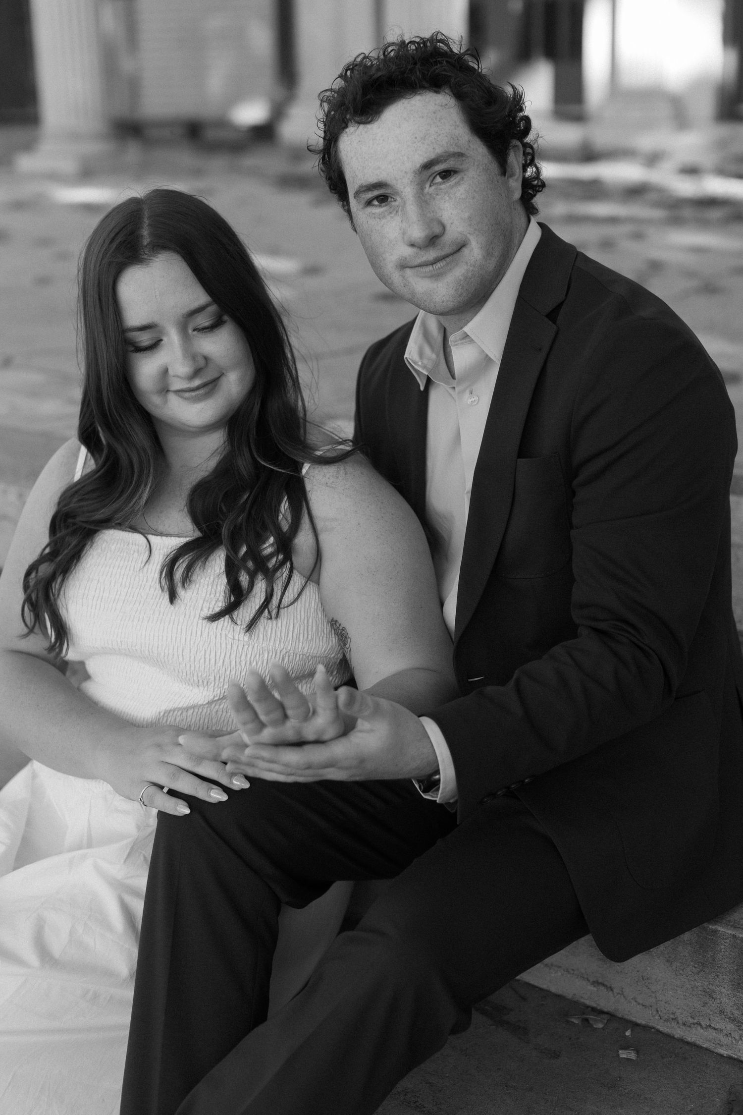 A romantic black and white portrait series of a couple in formal wear sharing intimate moments together.