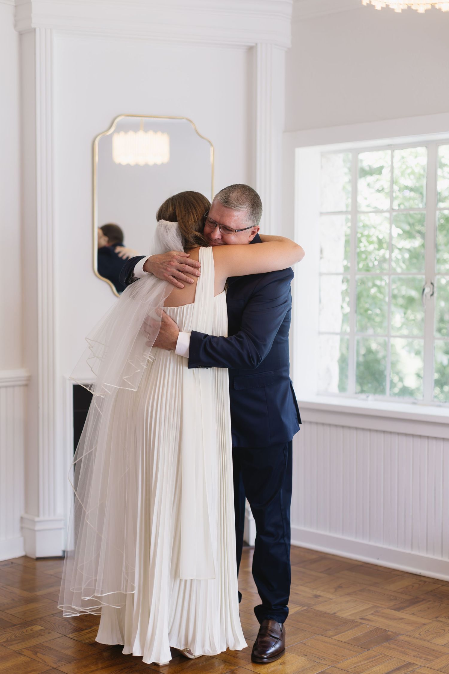 A tender moment between a couple in wedding attire sharing an embrace.