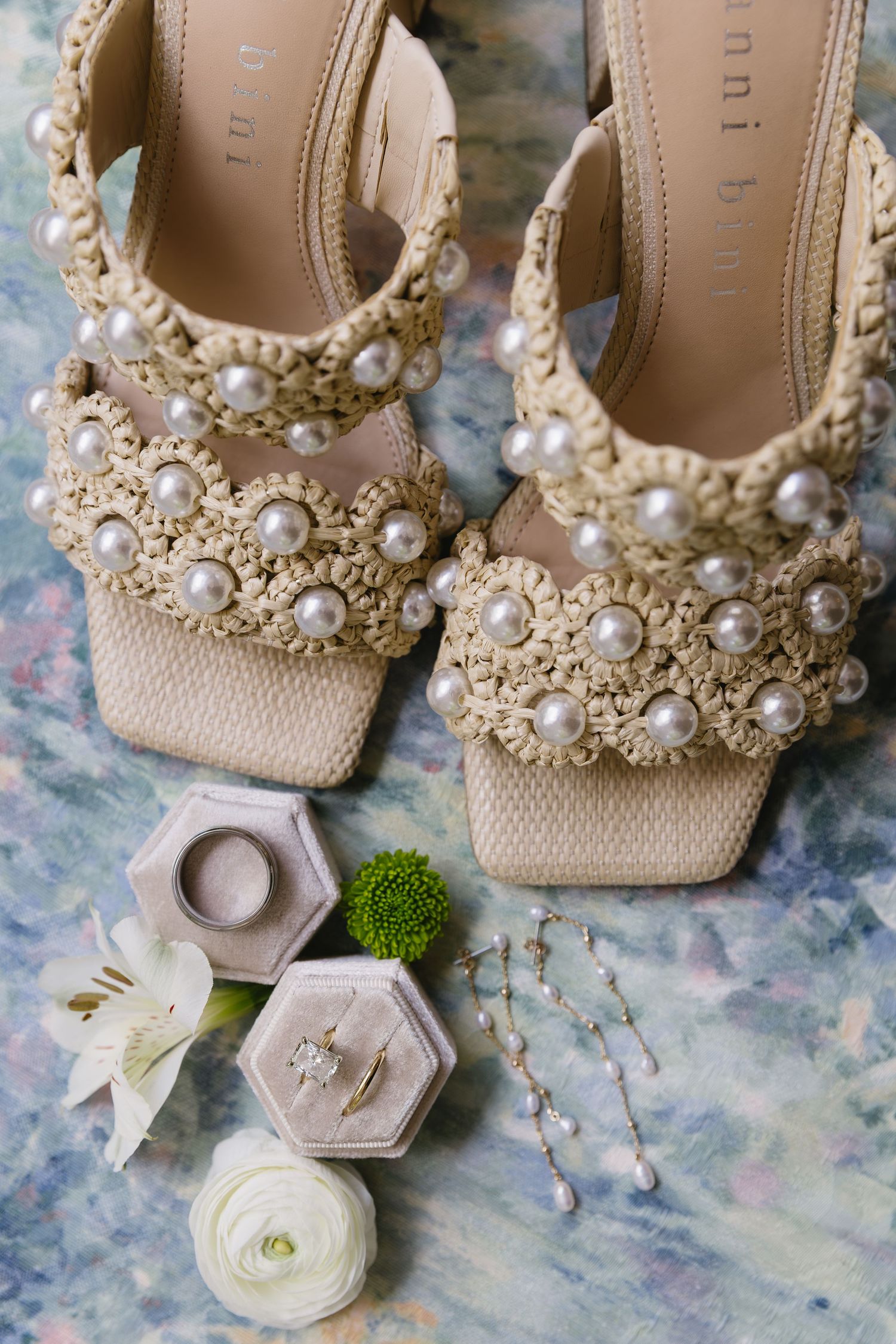 Pearl-encrusted beige wedding shoes with floral accents and hexagonal ring boxes.