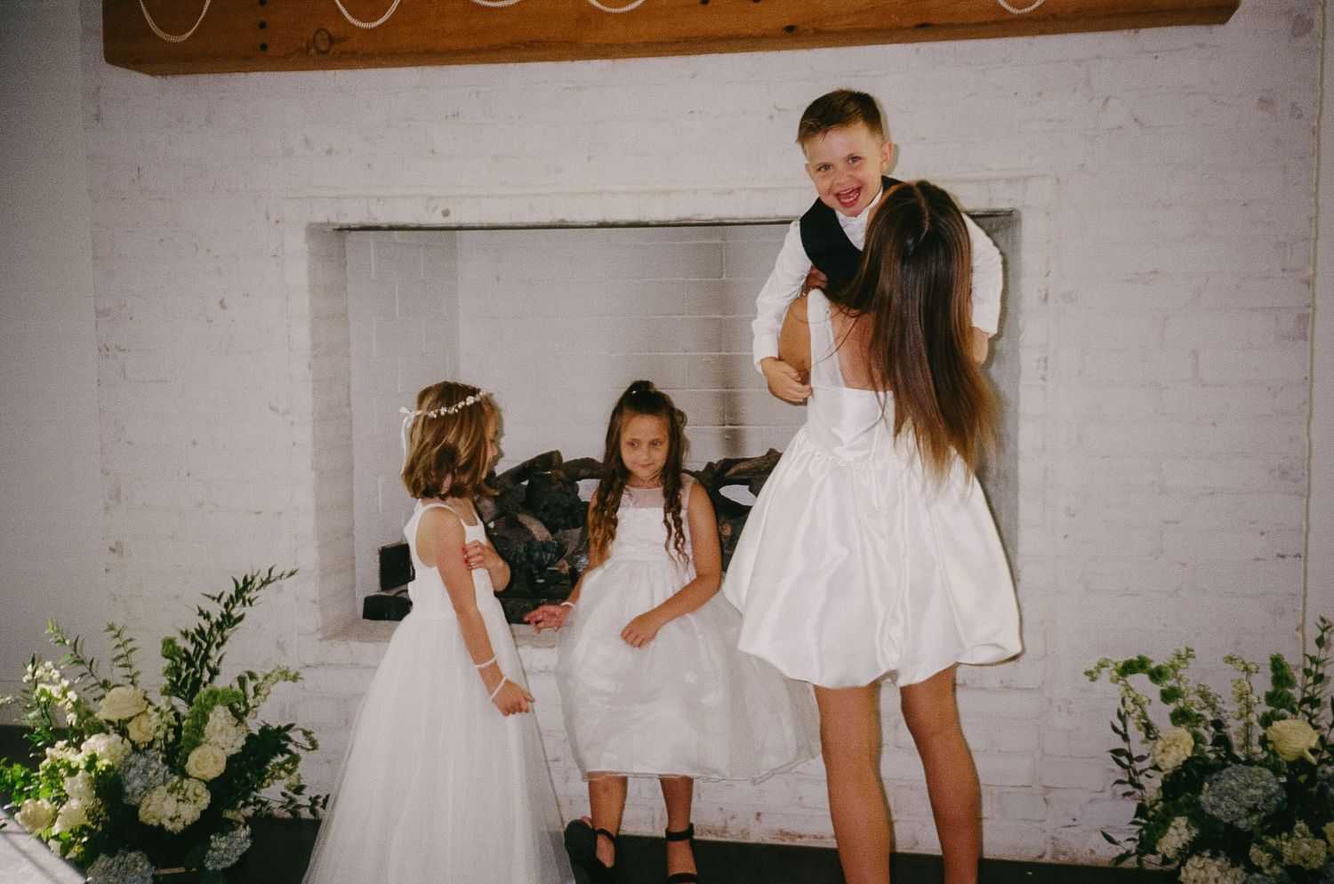 Wedding party members in black and white attire gather for celebrations.