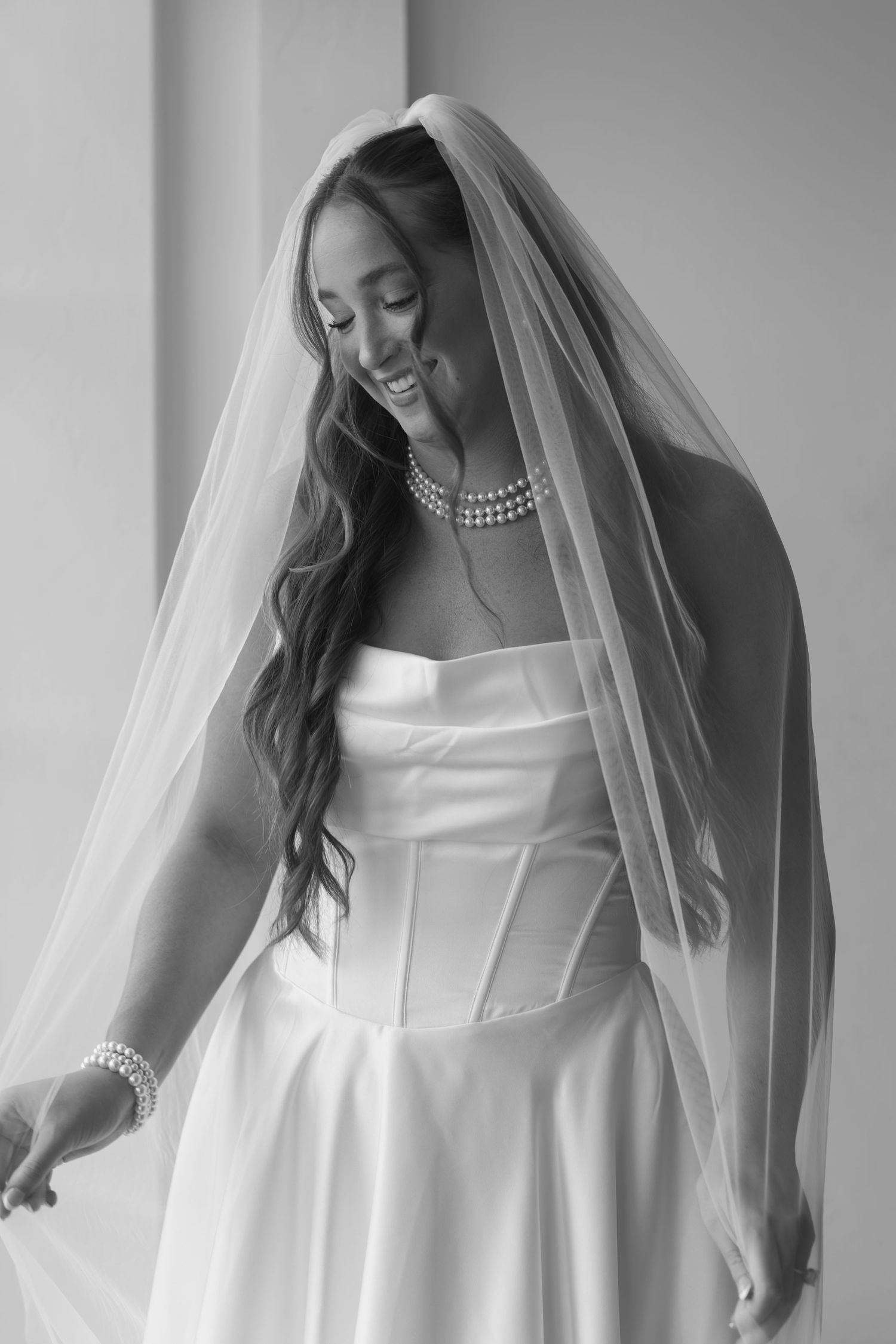 Close-up shots of a bride in an elegant white wedding gown with a flowing veil.