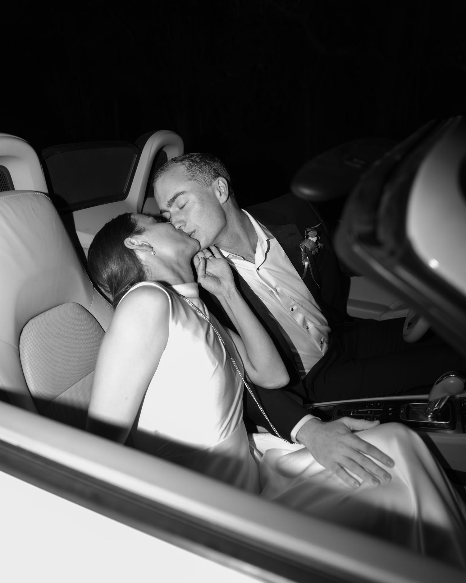 Artistic black and white shots of a couple resting together in a car.