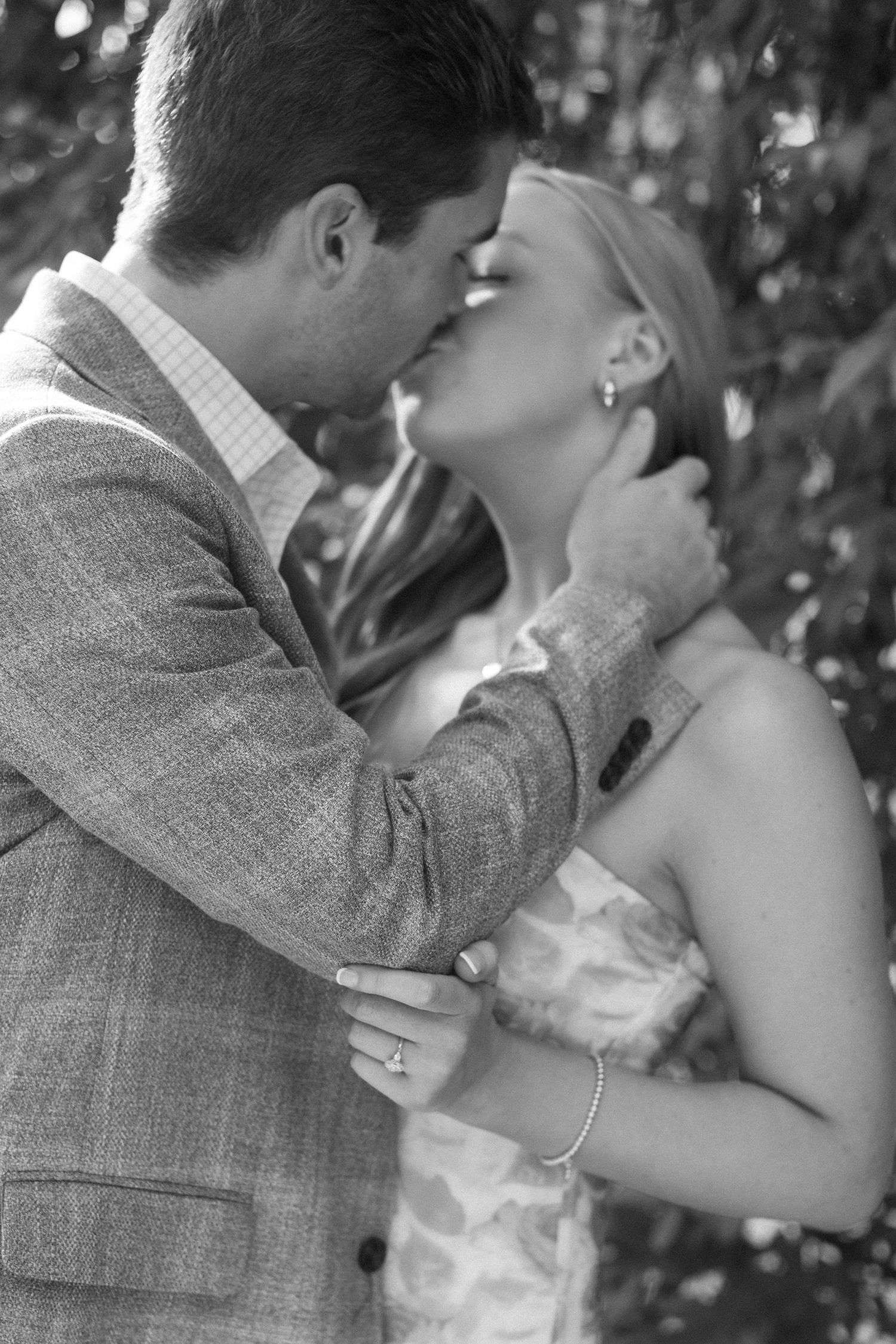 A series of intimate black and white photos capturing a tender embrace between two people.