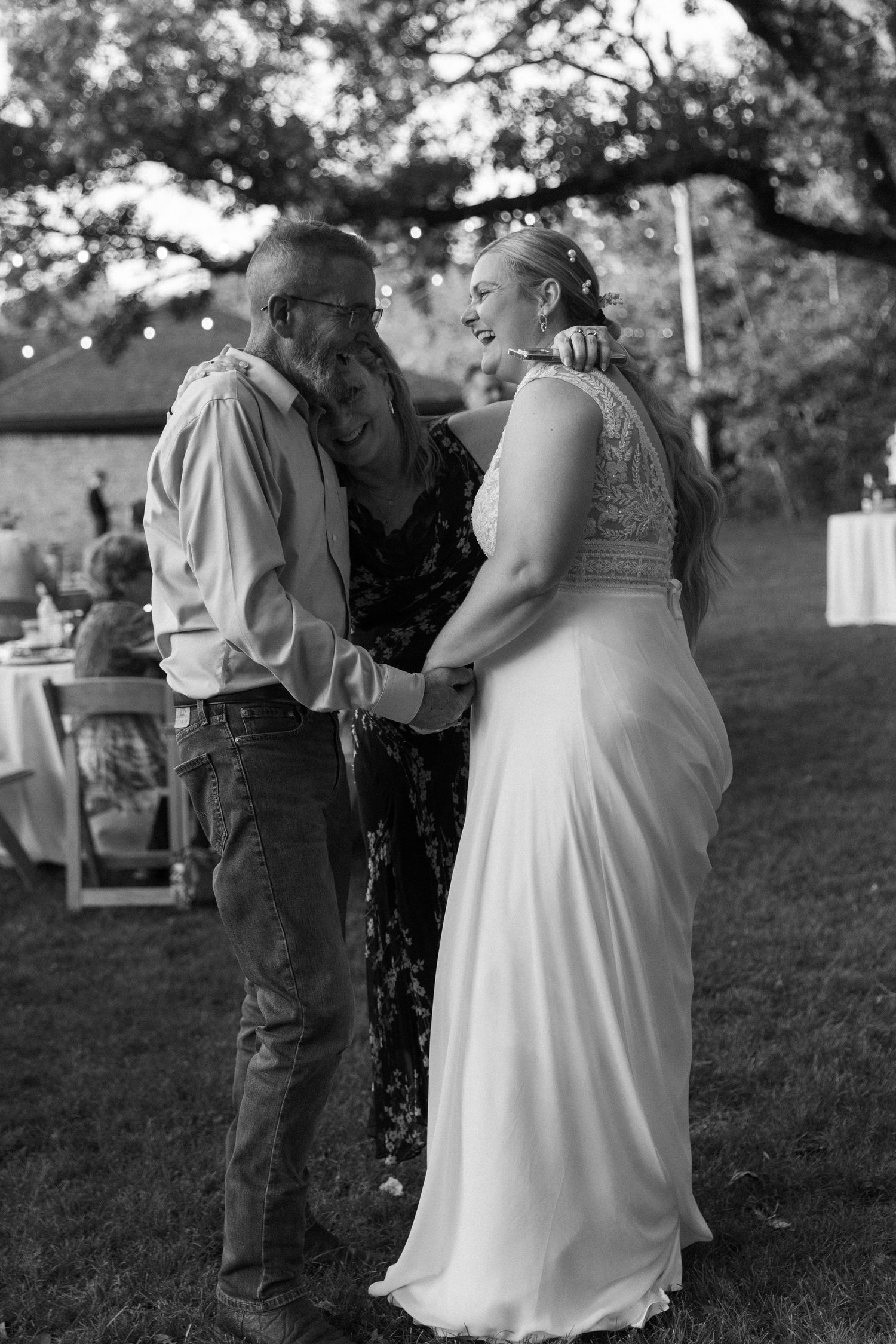 Black and white candid wedding moments captured in an outdoor garden setting.