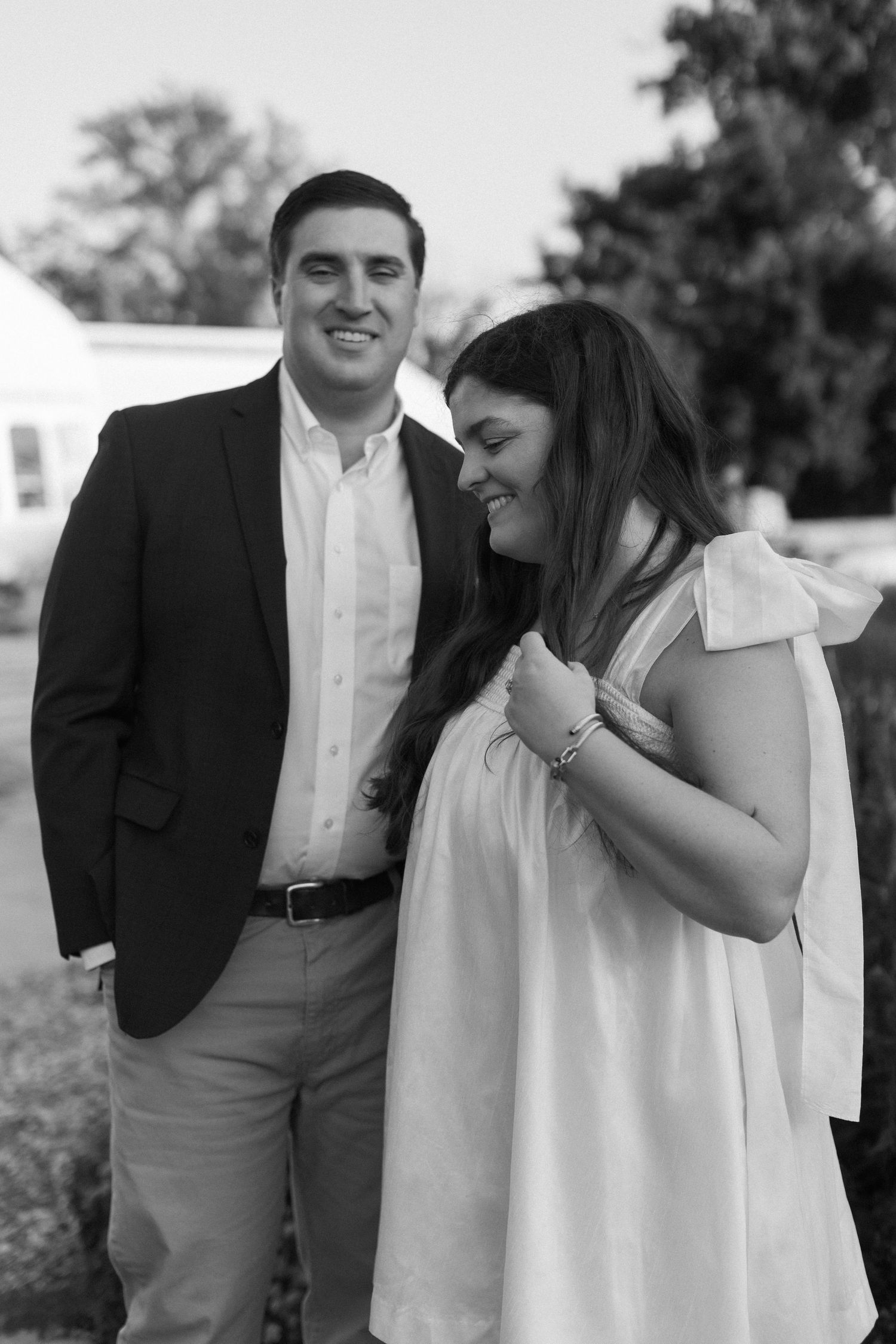 A black and white photo collection of a couple embracing during their engagement shoot.