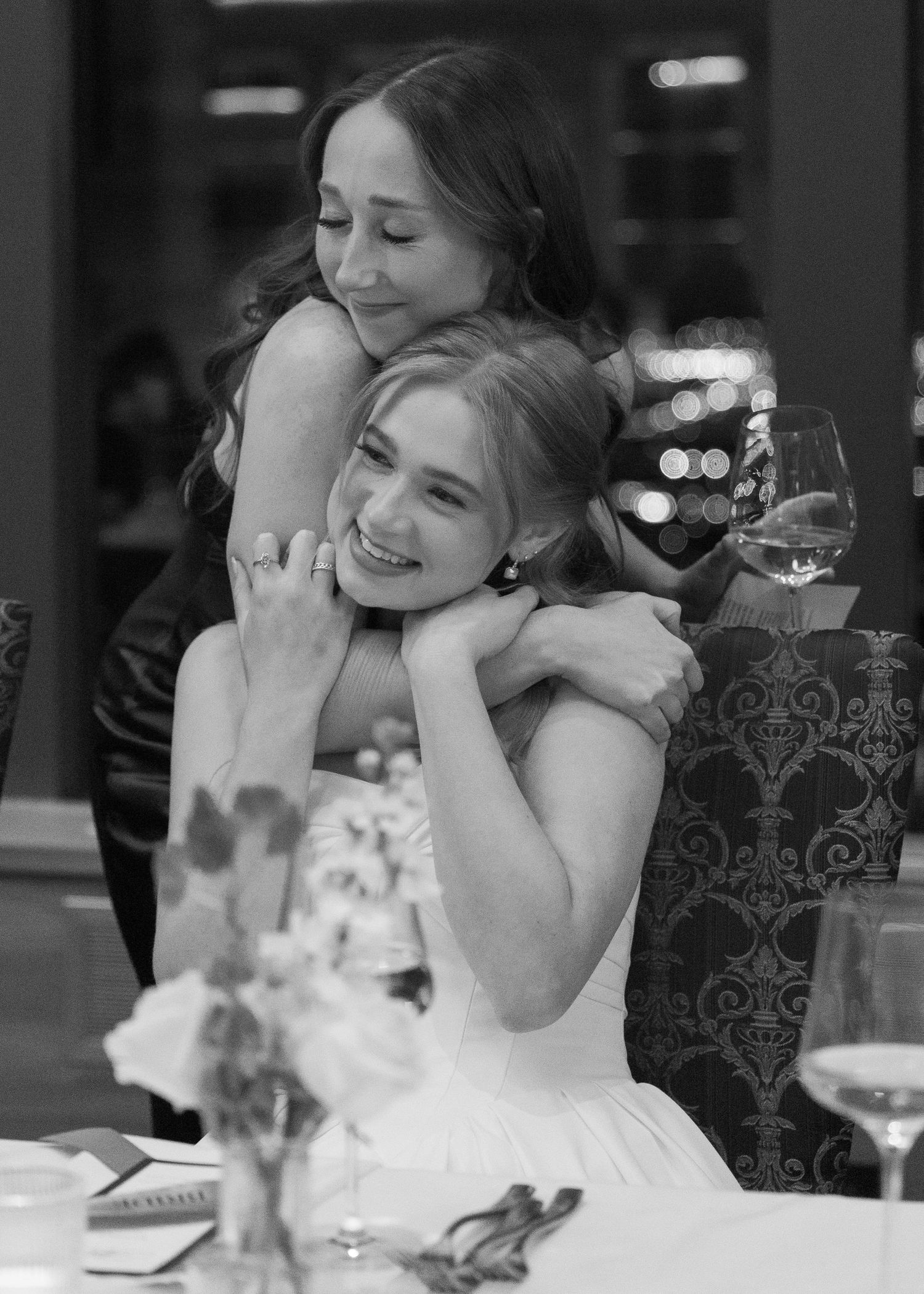 Wedding guests share joyful moments at an elegant reception dinner.