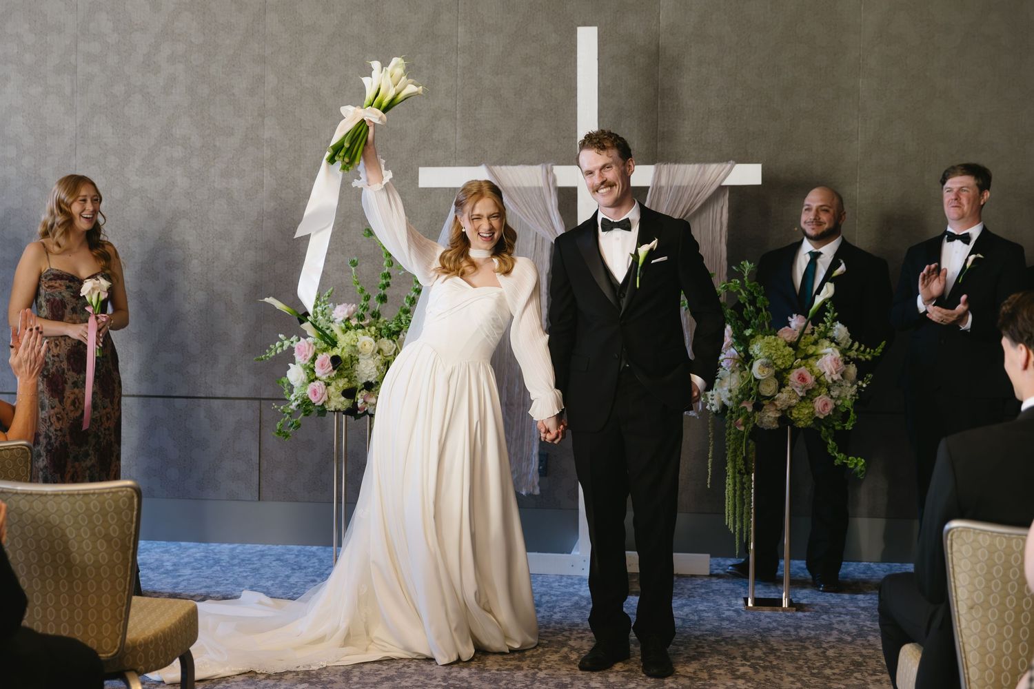 Wedding party photos in a modern venue with elegant decor.