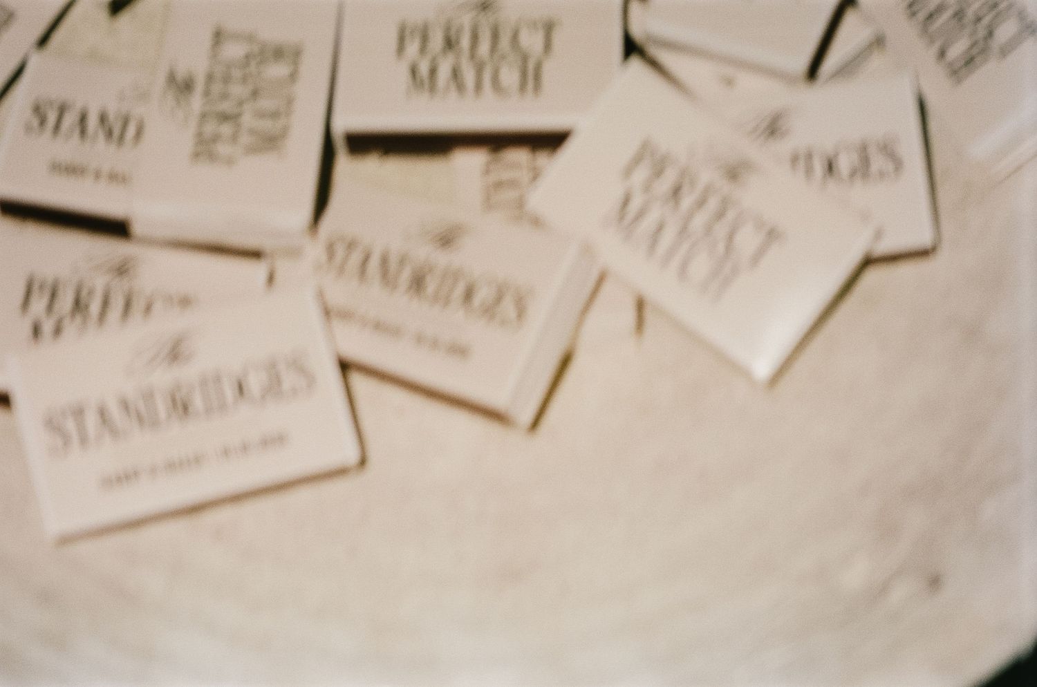 Multiple place cards arranged on a light colored surface at a wedding reception.