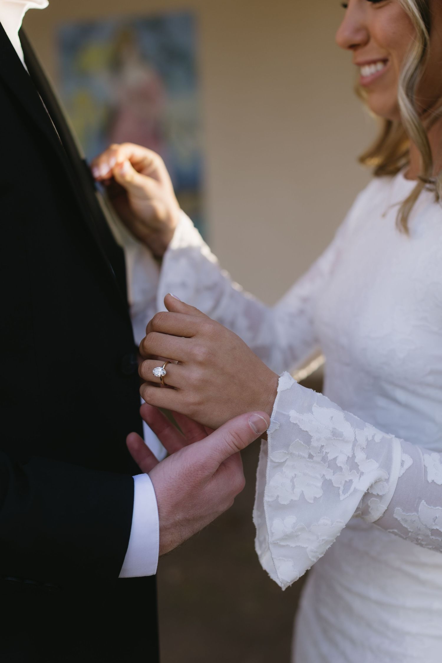 Close-up of hands exchanging wedding rings during a ceremony.