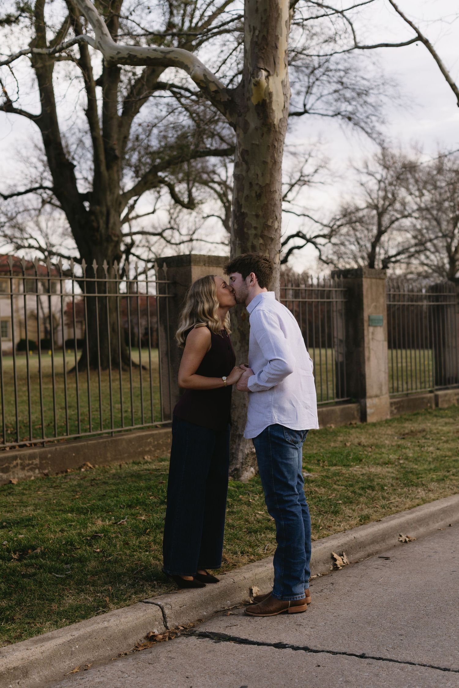 A series of candid moments between a couple on a path near an iron fence.