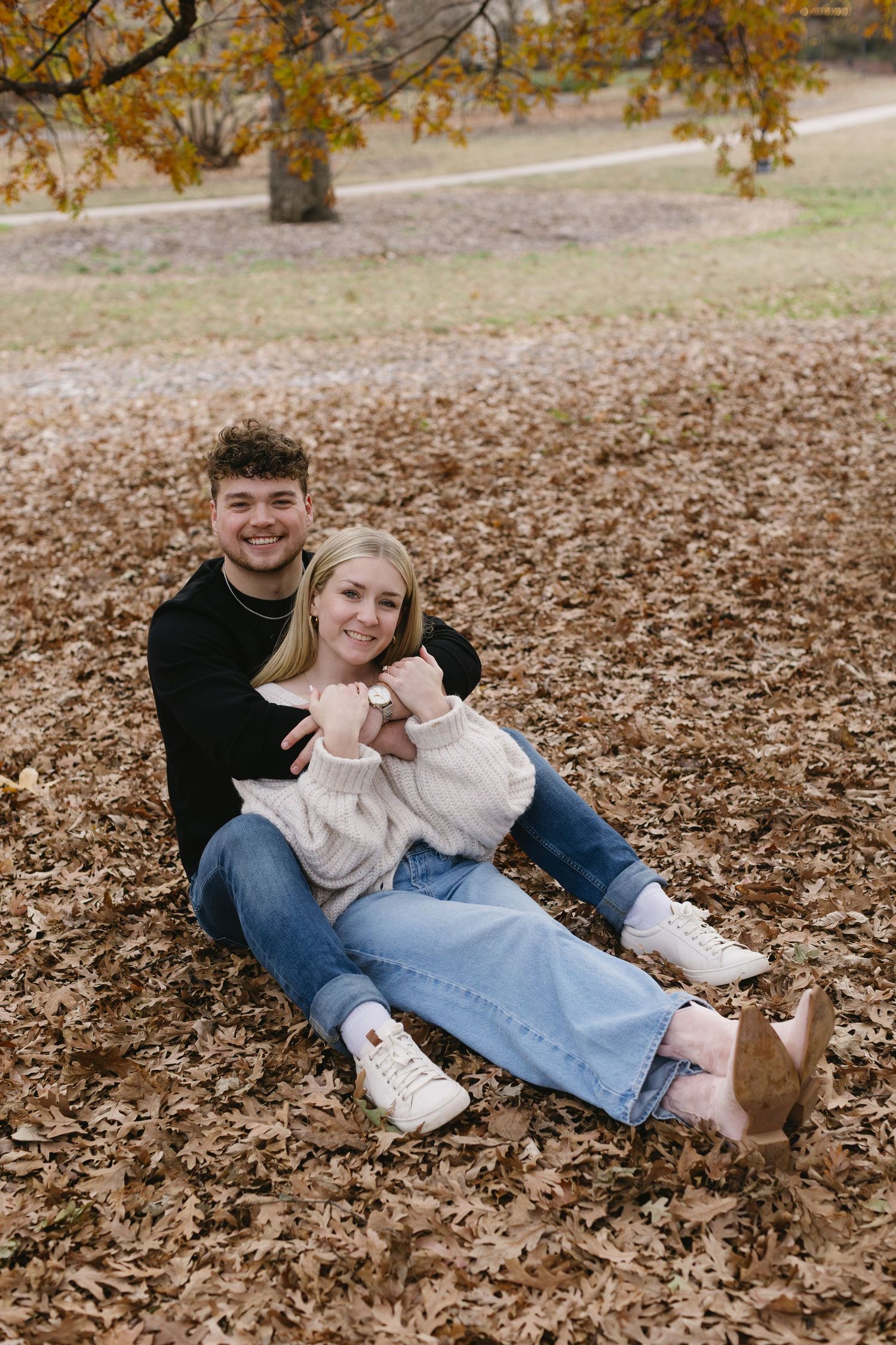 A playful autumn photoshoot with fallen leaves and laughter.