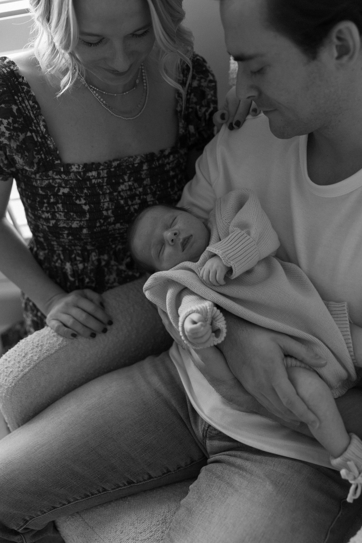 Intimate black and white photos of family sharing tender moments together.