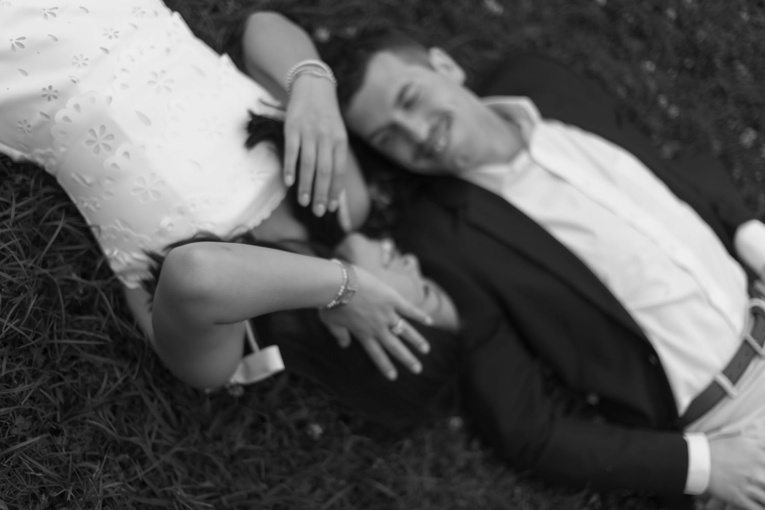 Intimate black and white photo sequence showing gentle moments on the grass.