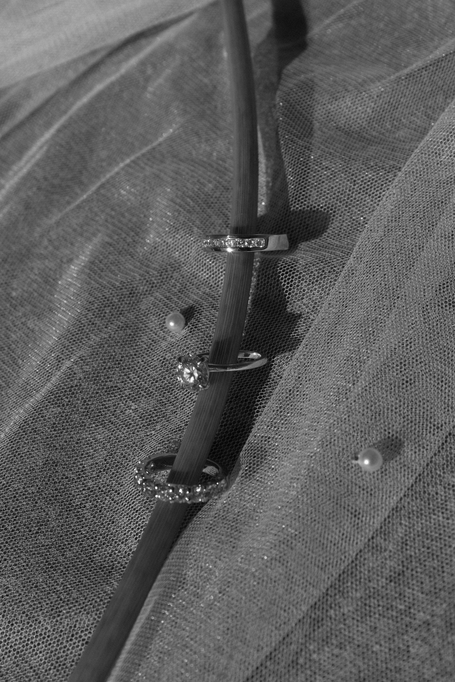 Close-up detail of elegant black high heels with sparkly embellishments against a textured background.