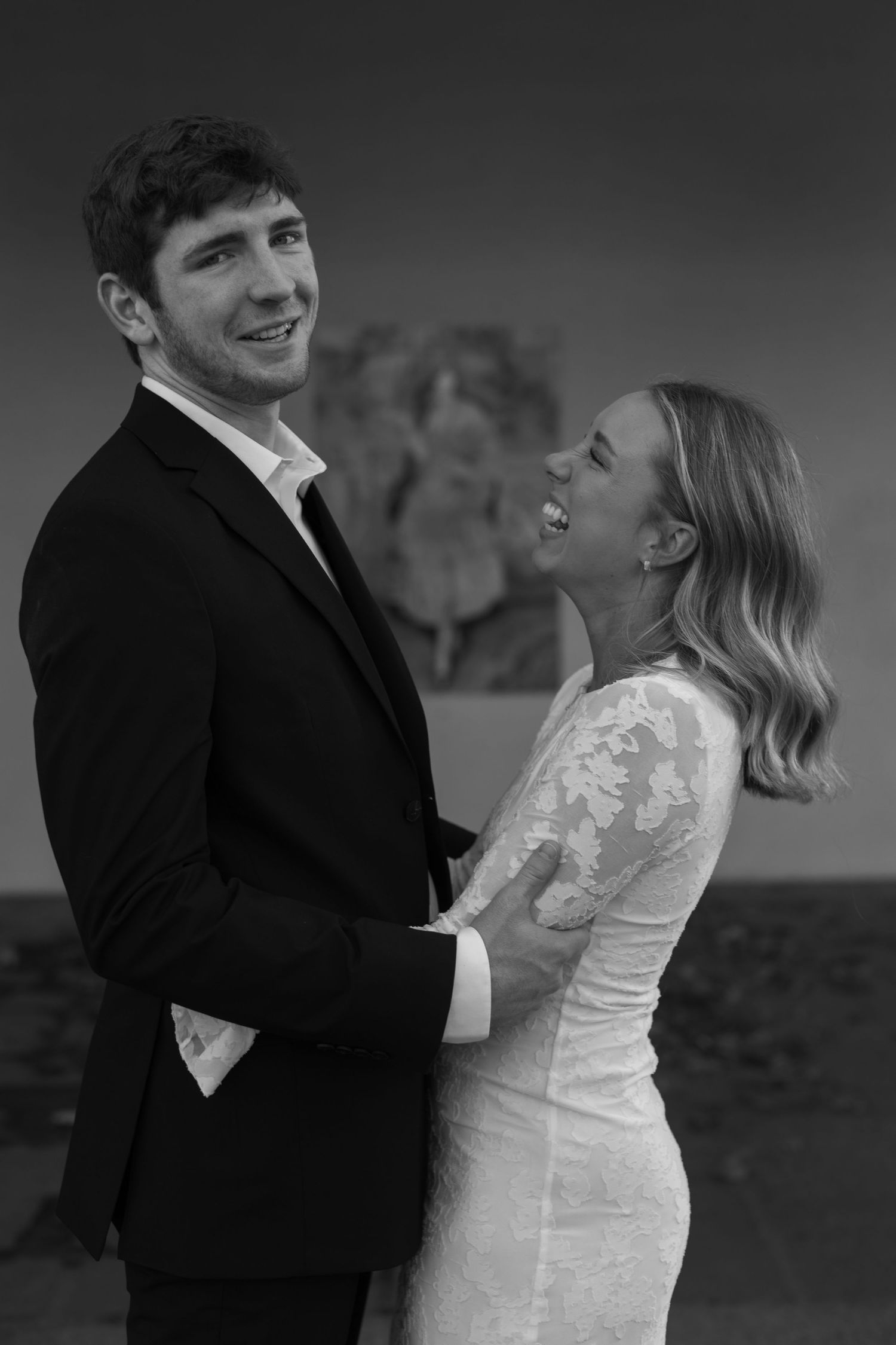 A romantic black and white photo sequence showing a couple embracing and laughing together.
