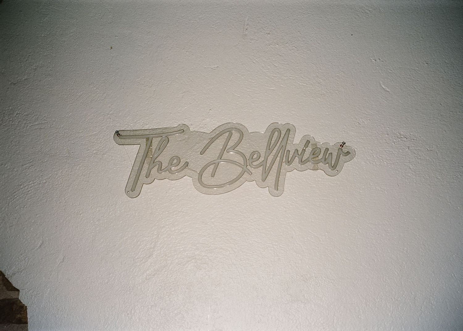 Faint text or signature visible against a light gray textured background.