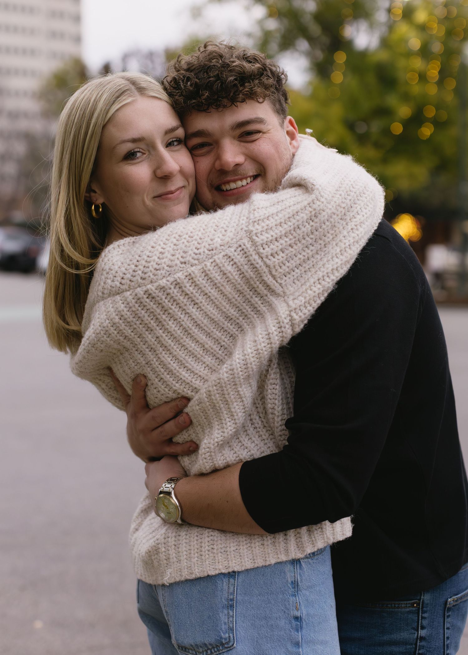 Couple shares tender moments outdoors wearing matching casual outfits during autumn.