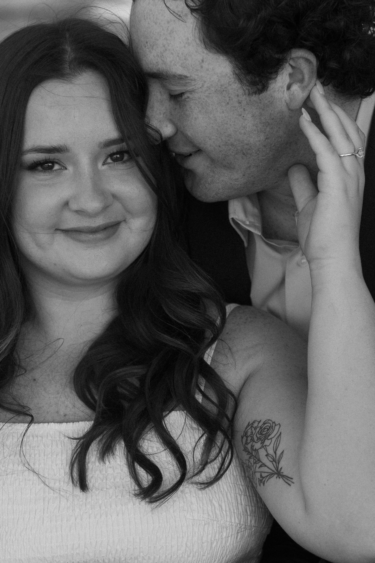 A series of five black and white romantic photos showing tender moments between a couple.