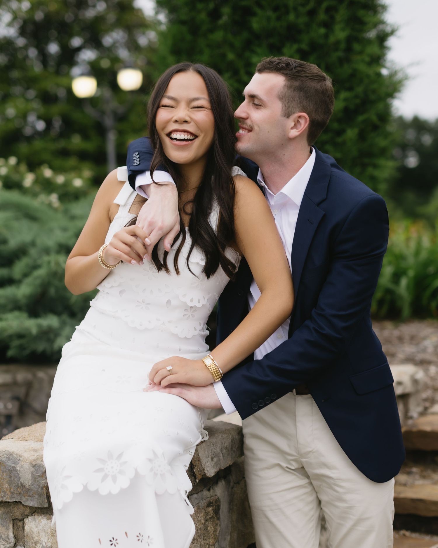 Joyful outdoor wedding photo sequence showing intimate moments on stone steps surrounded by greenery.